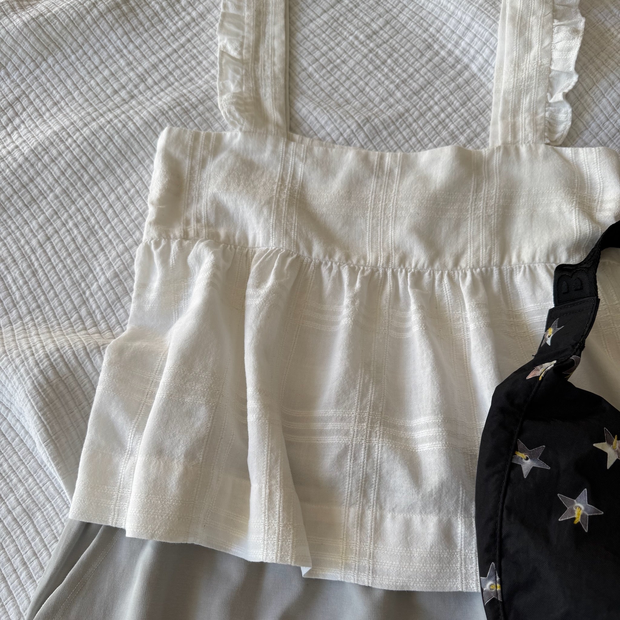 White Cami Top with frill on wide strap and blue skirt laid on bed - ANNIE.G