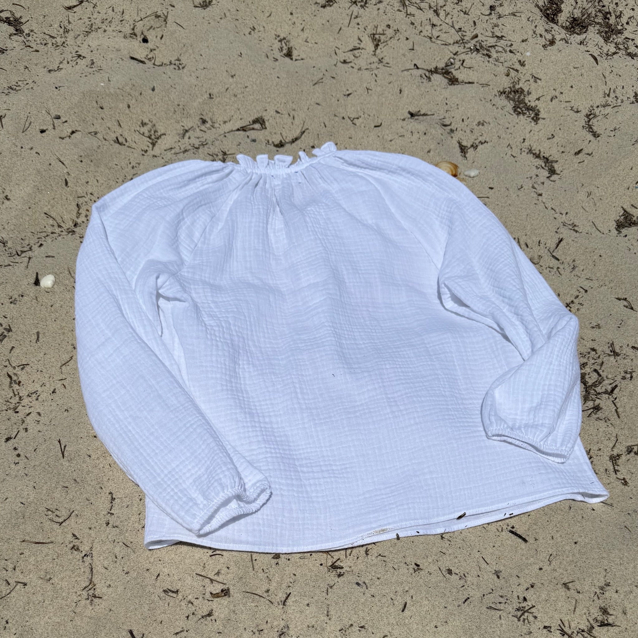 Back of a white cotton gauze shirt on sand - ANNIE.G