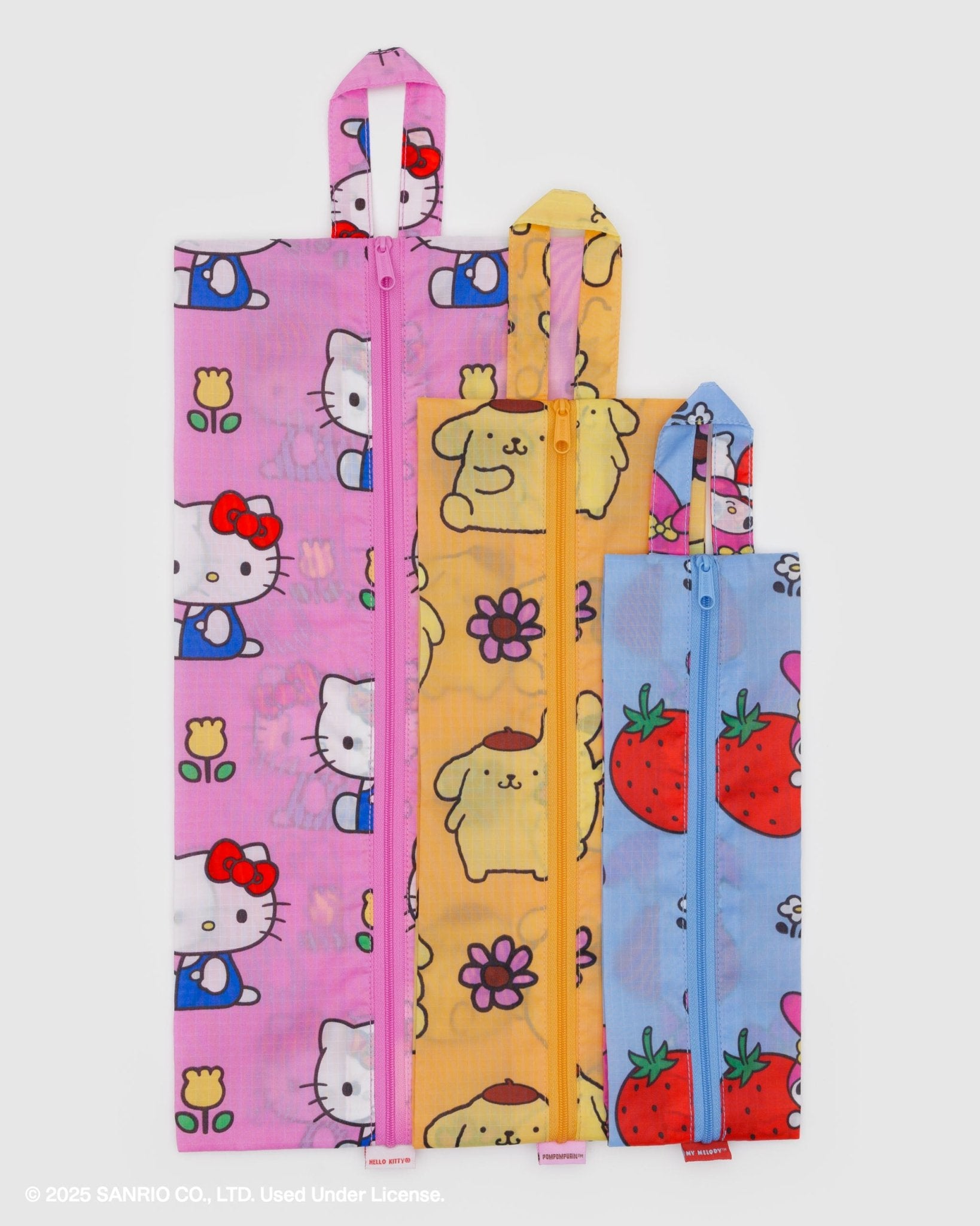 Three colourful zip bags with hello kitty and friends florals cartoon designs and hanging loop at the top