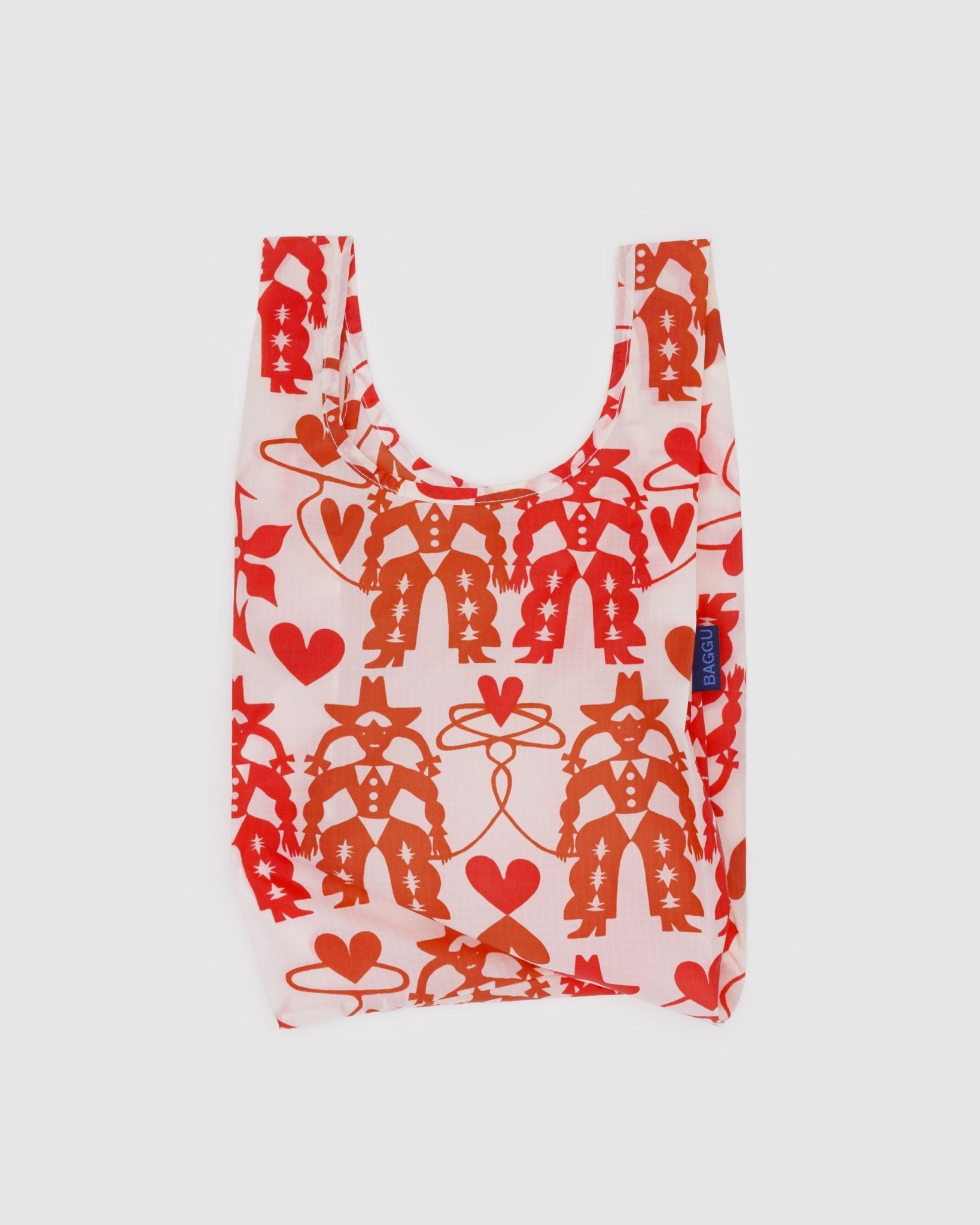 Baby size reusable shopping bag with red cowgirl and heart patterns and BAGGU tag on the side