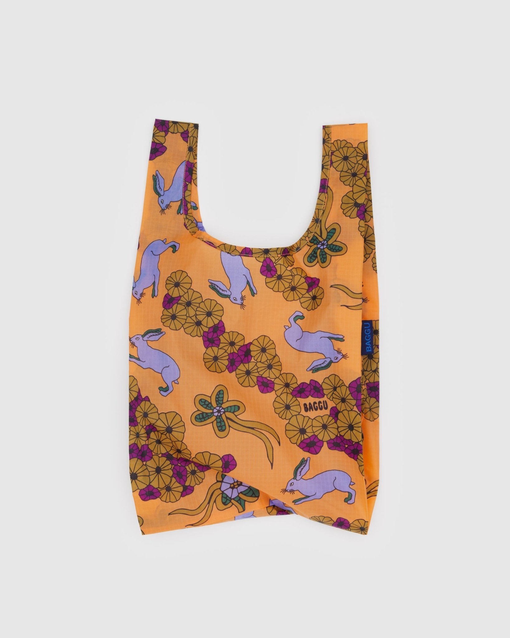 Baby sized, reusable orange bag with purple rabbit and floral pattern and BAGGU branding