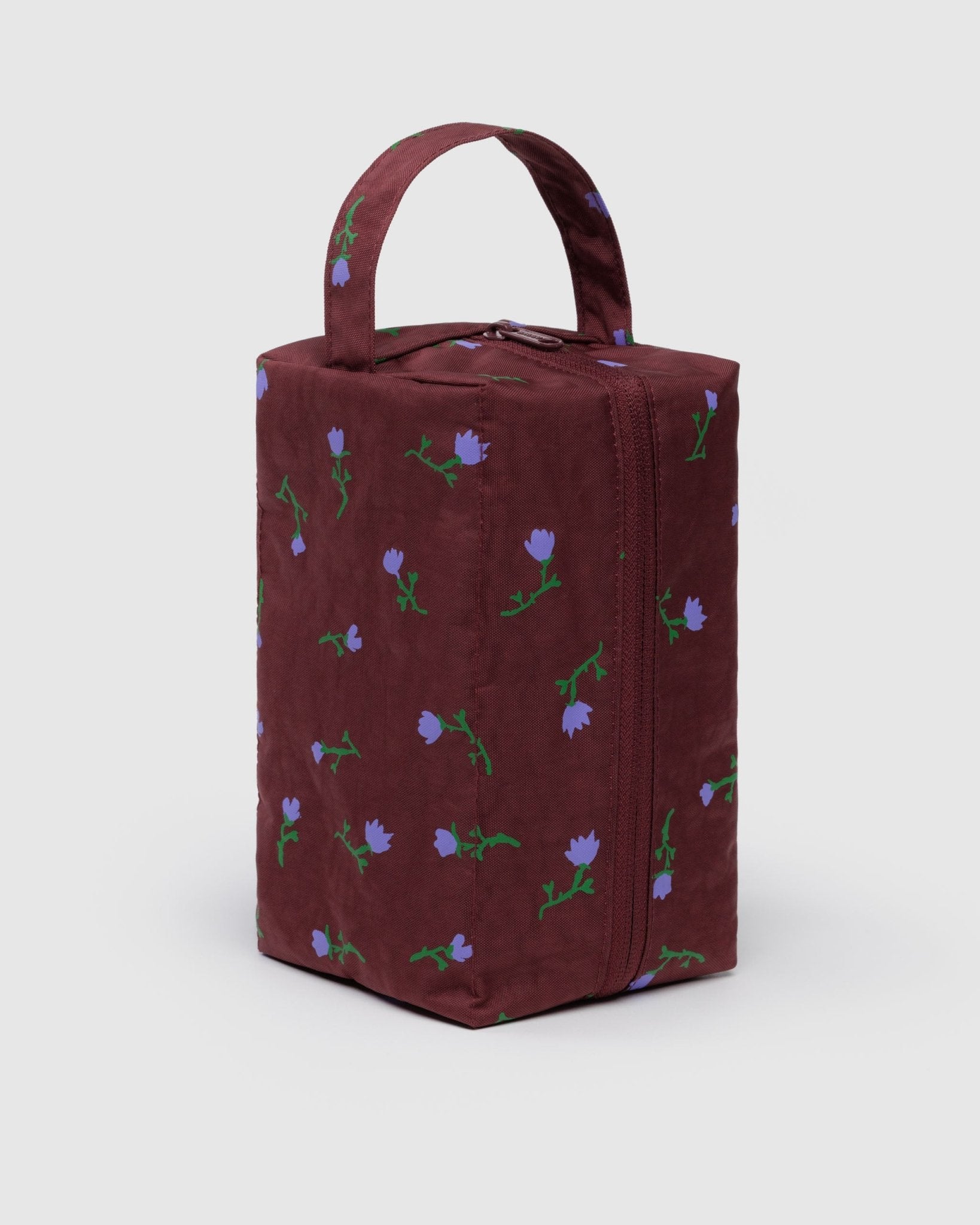Mahogany toiletry bag with purple wildflower patterns, zipper closure and carry handle