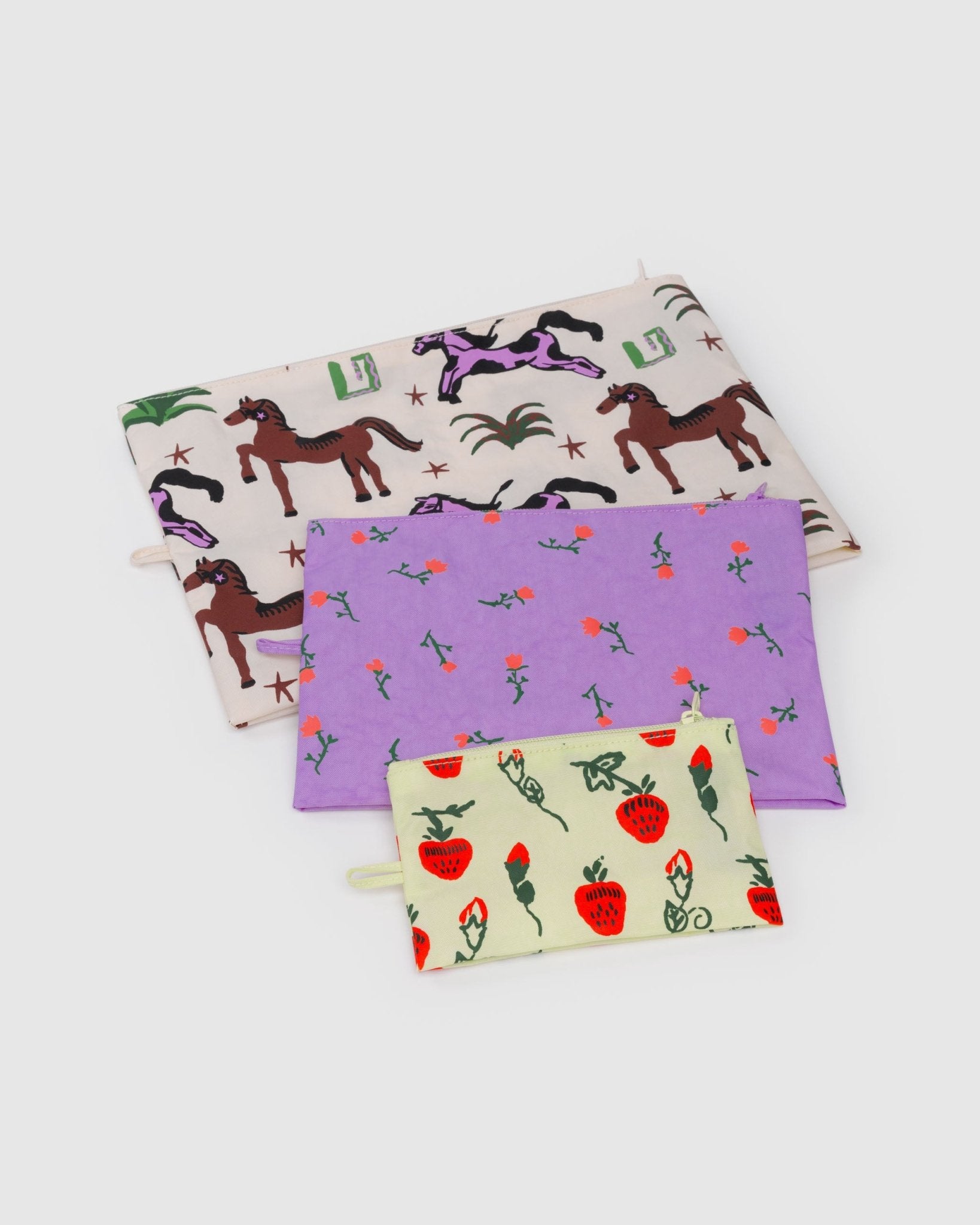 Set of three zippered pouches with different patterns unfilled and lying flat