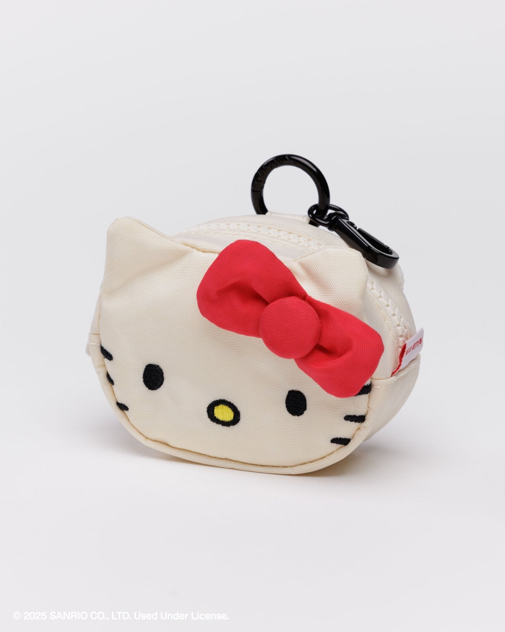 Hello Kitty face embroidered on a round coin purse with a red bow near ear and black ring with a carabiner and zip top