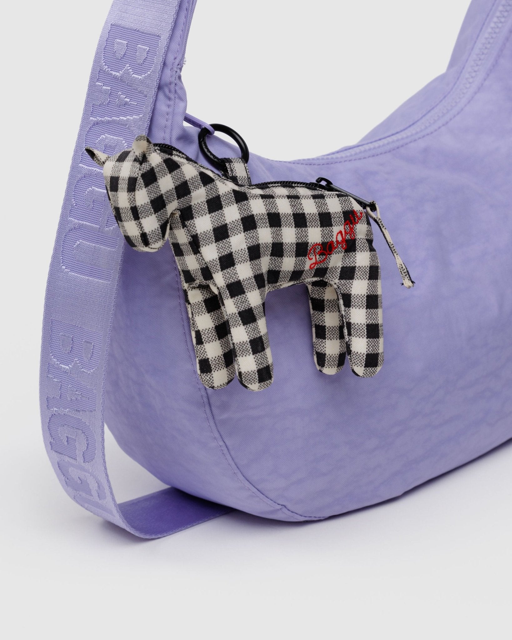 Horse charm in Black and White Gingham attached to purple crescent bag zip with metal clip