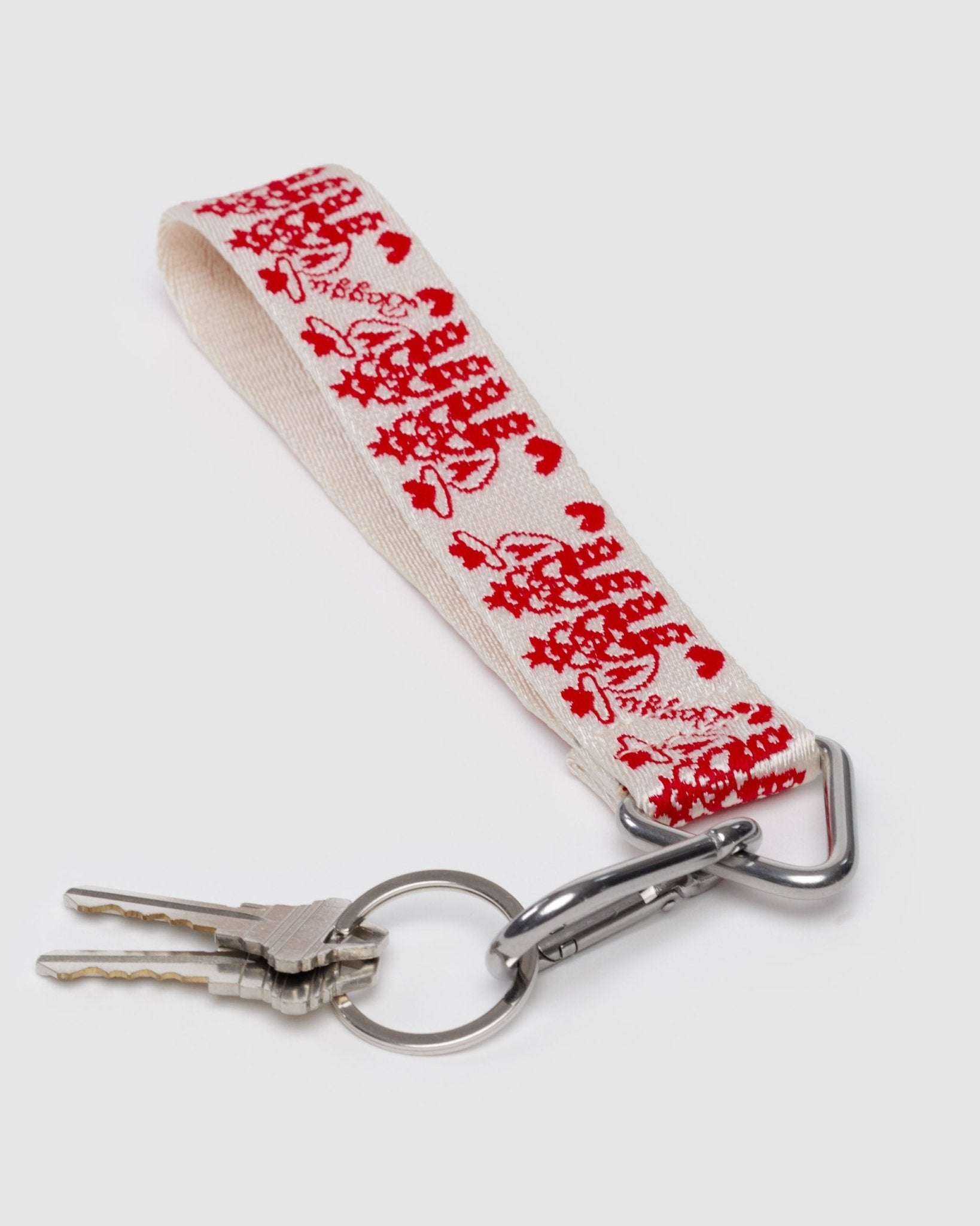 Keychain with red cowgirl patterns on a white strap with keys attached to clip