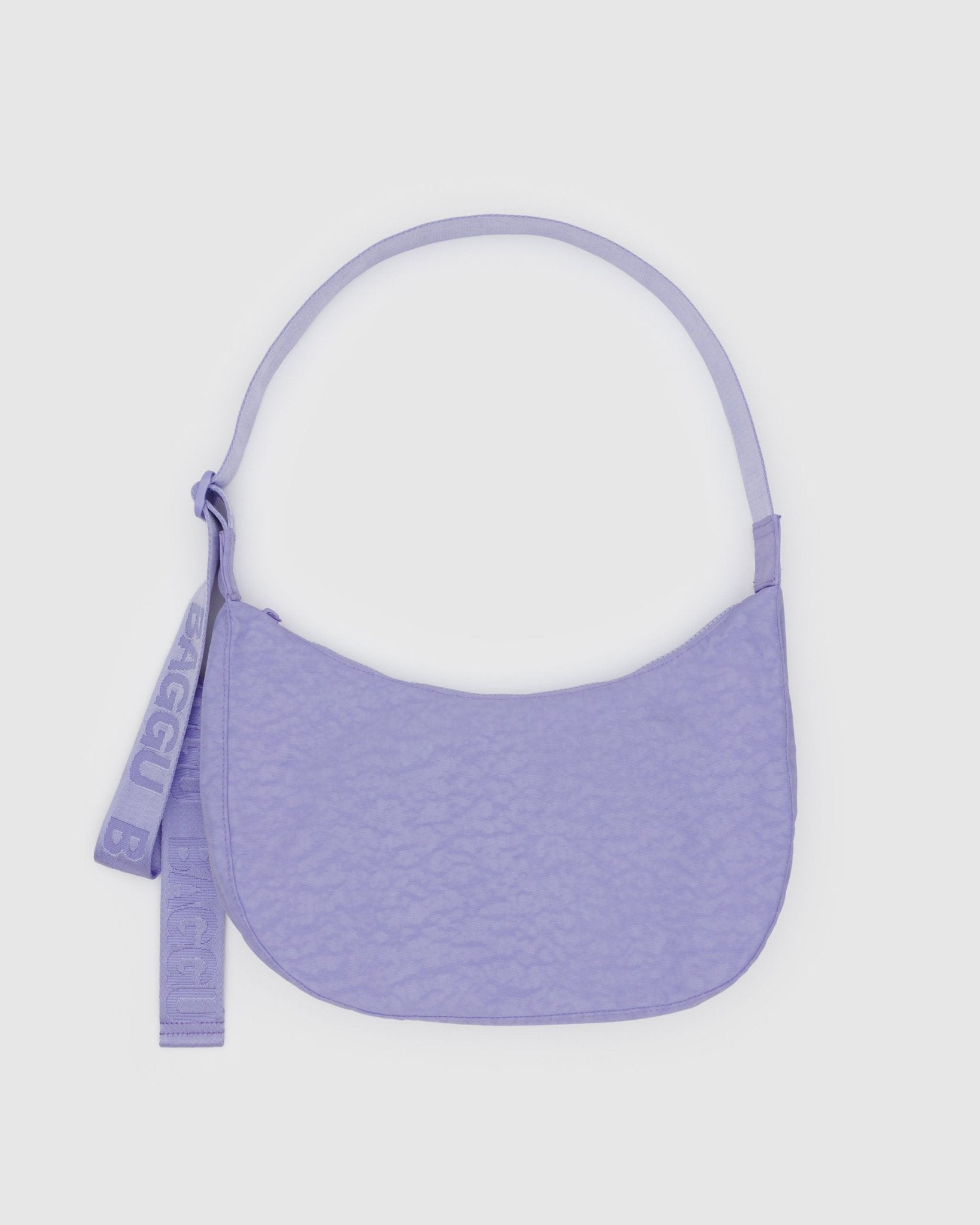 Purple handbag with an adjustable strap and zip top