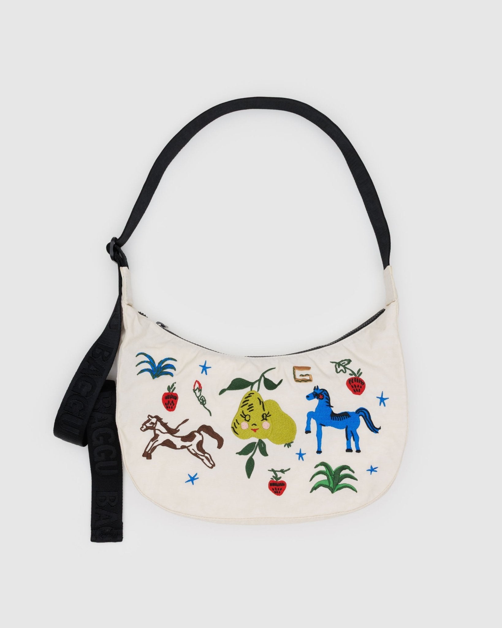Ecru medium crescent bag with black adjustable shoulder strap, zip top and horse and strawberry print
