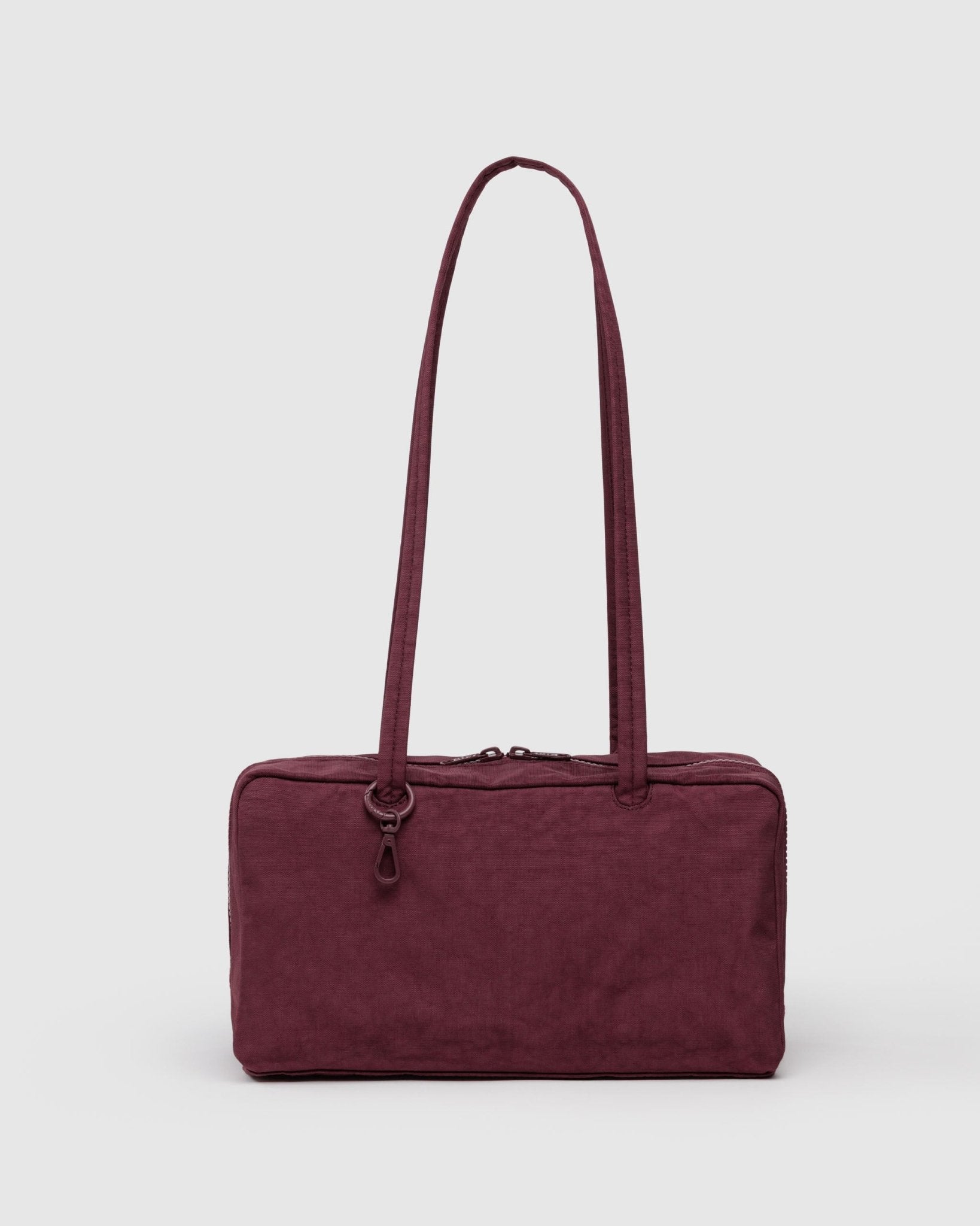Maroon handbag with double handles, zip top and metal charm clips