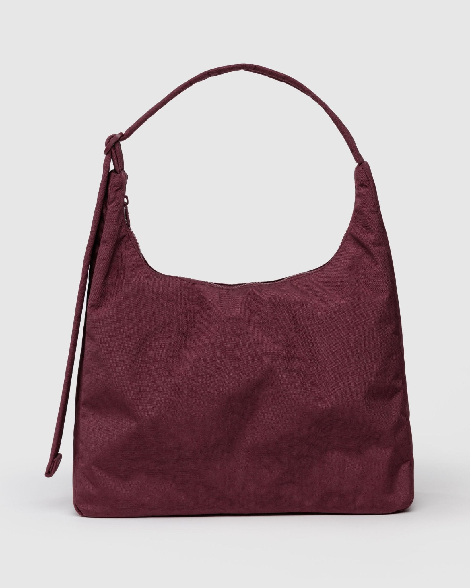 Maroon handbag with adjustable shoulder strap and top zipper
