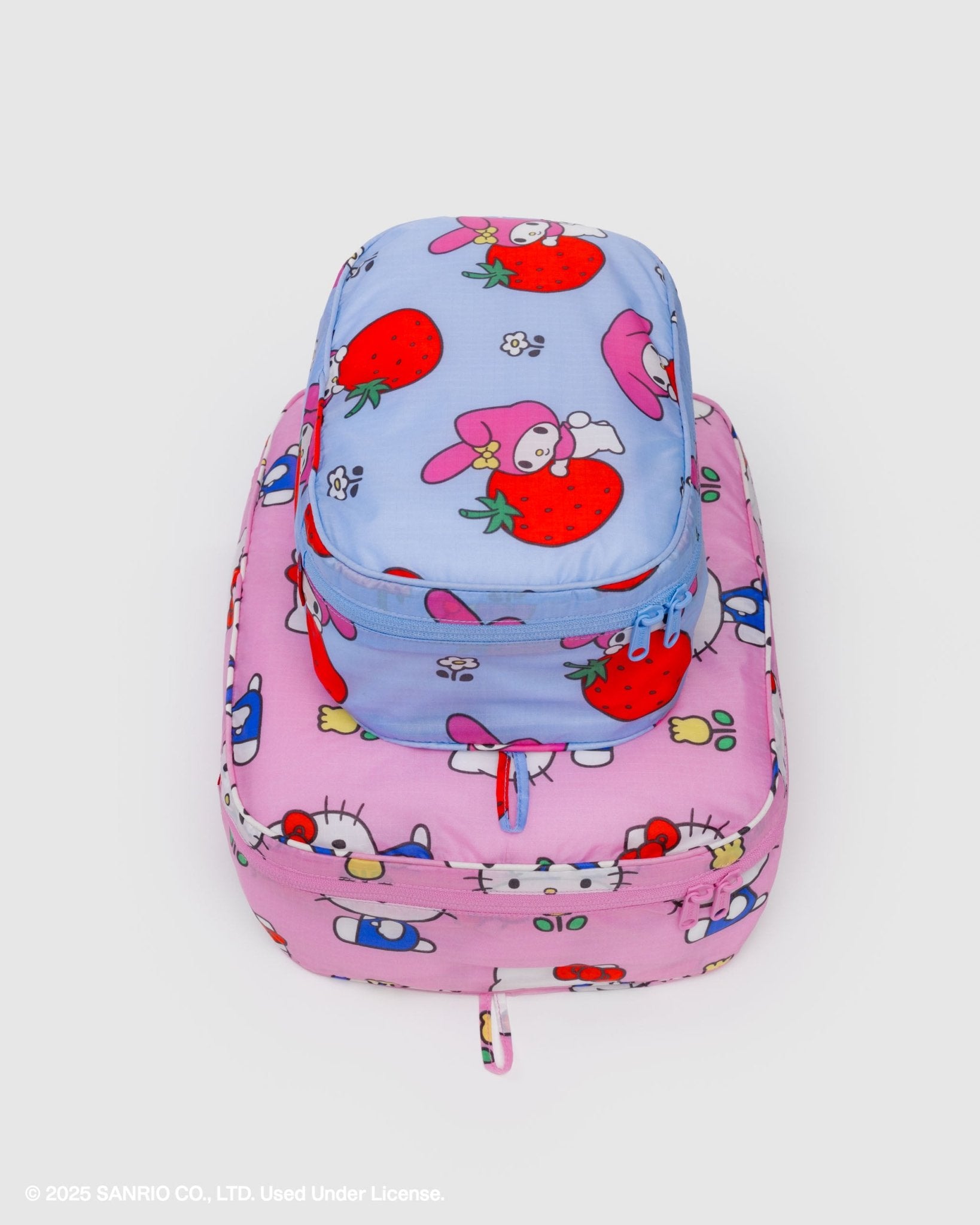 Filled pink and blue filled packing cubes with cartoon character design with zip closure and stacked