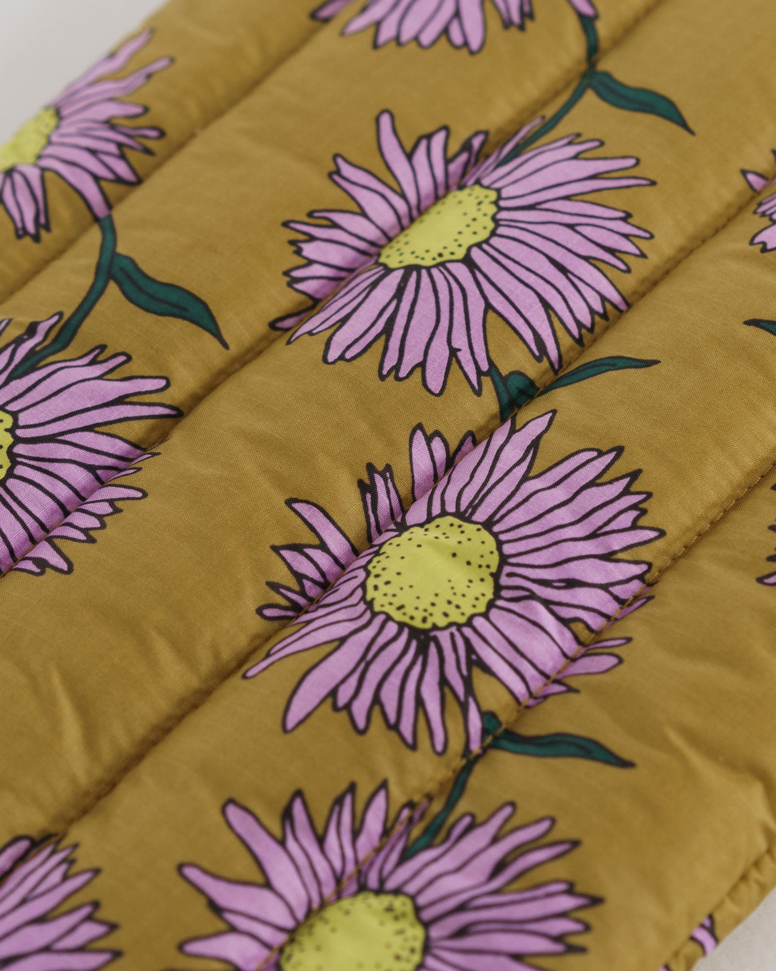 Floral patterned nylon laptop sleeve with pink flowers and green leaves on a mustard yellow background