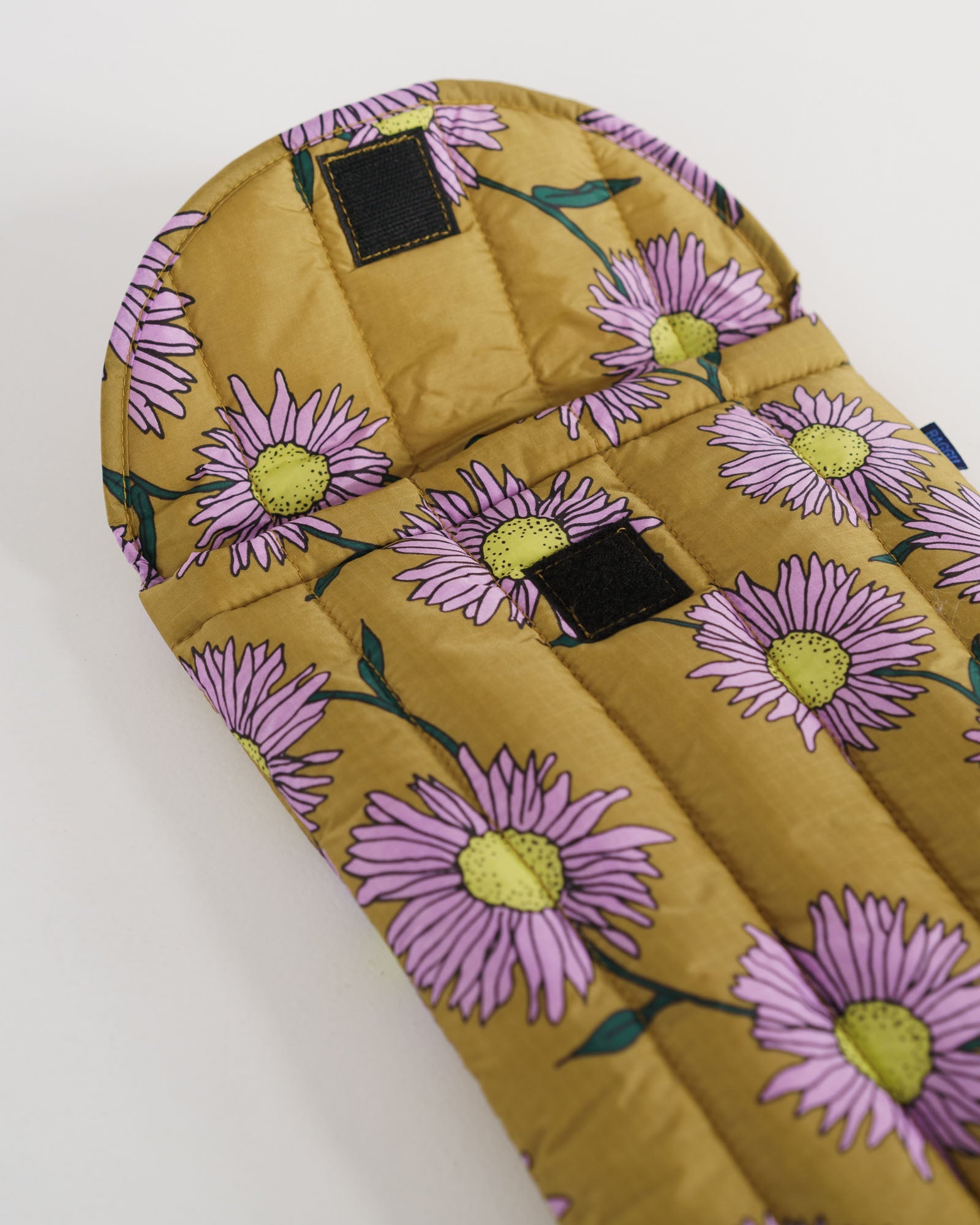 Pink daisy floral-pattern on brown background of laptop sleeve with velcro closure open