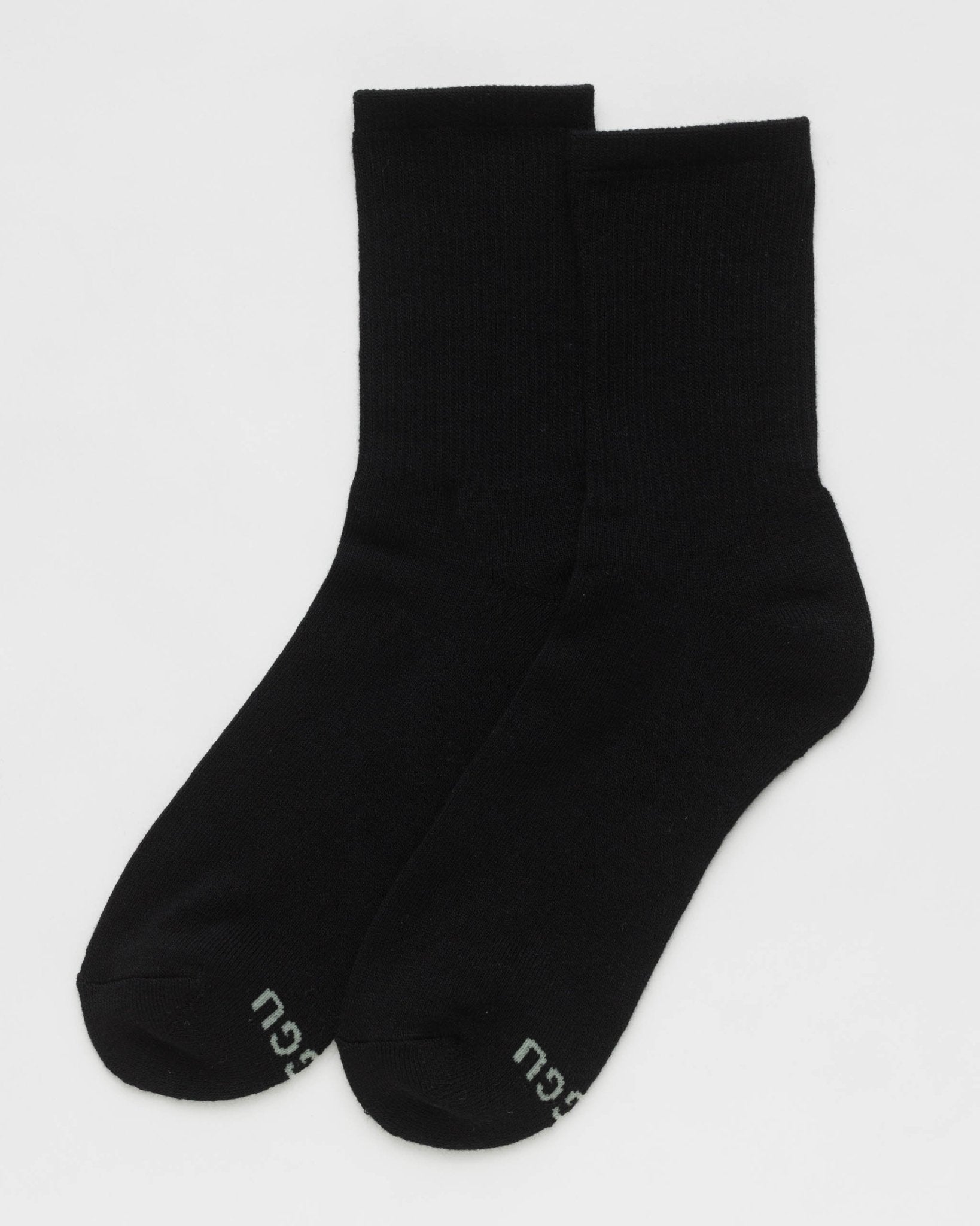 Two black bamboo ribbed socks with BAGGU brand on sole