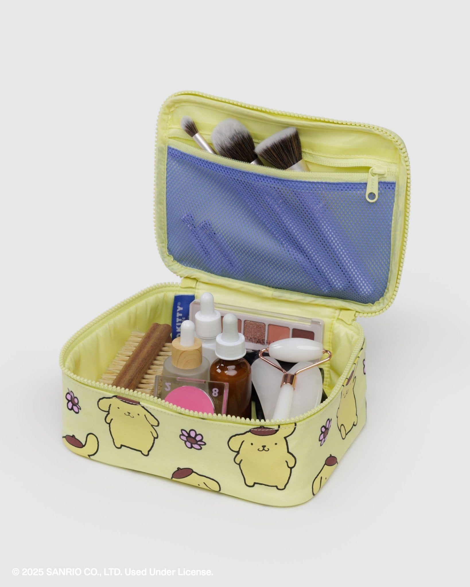 Yellow small makeup bag with cartoon character design, open to reveal cosmetic items and zip pouch on lid