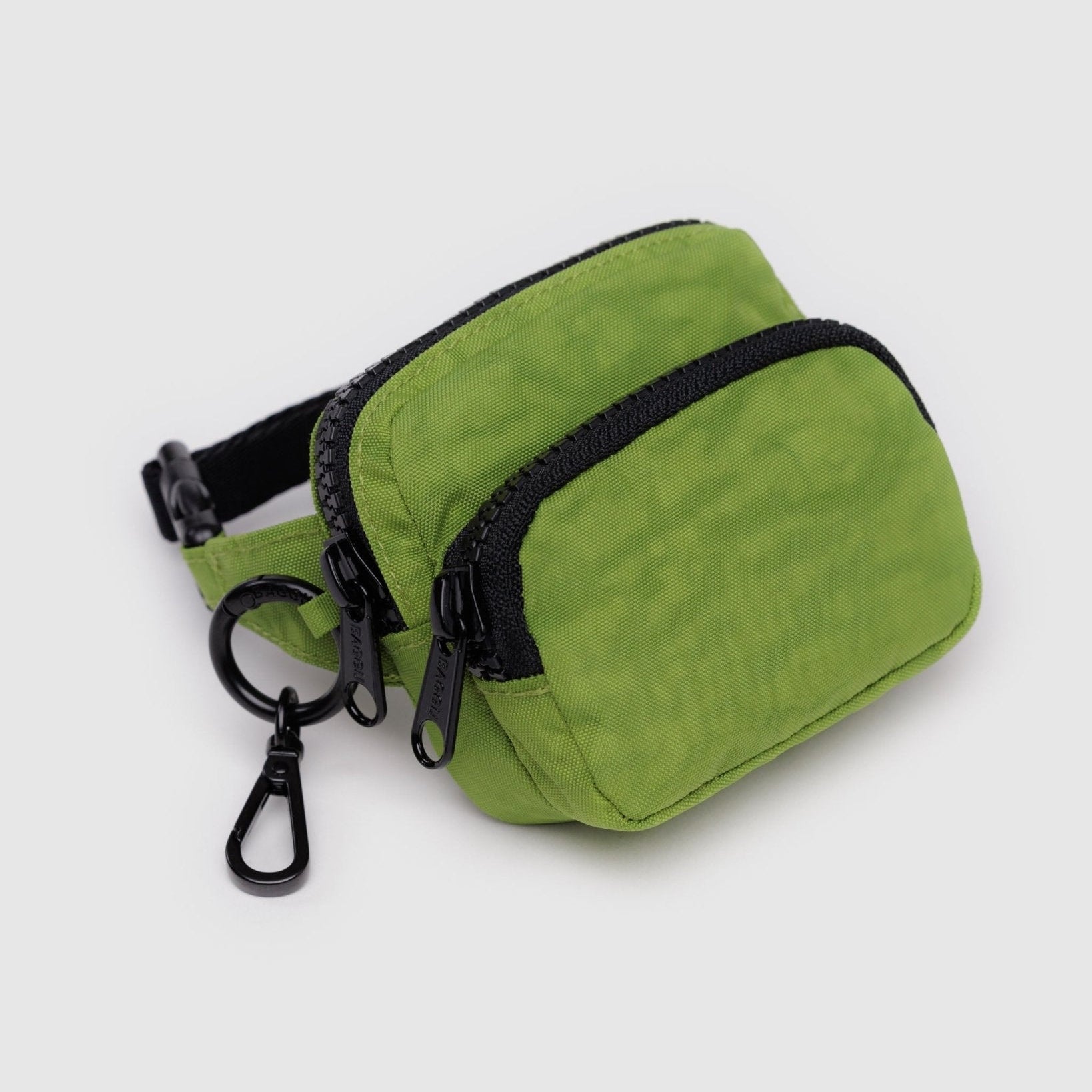 Green coloured pouch with adjustable logo black strap, two zip pockets and metal keyring with clip.