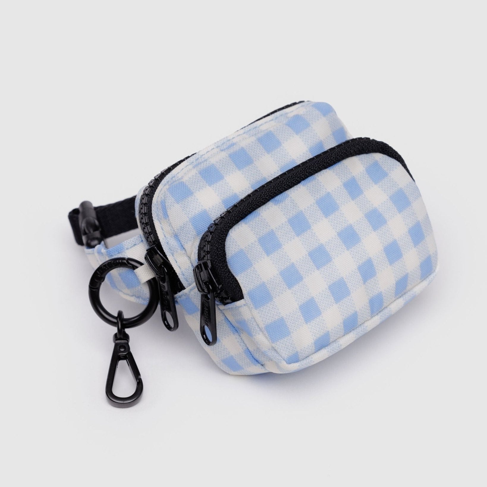 light blue gingham patterned pouch with adjustable logo black strap, two zip pockets and metal keyring with clip.