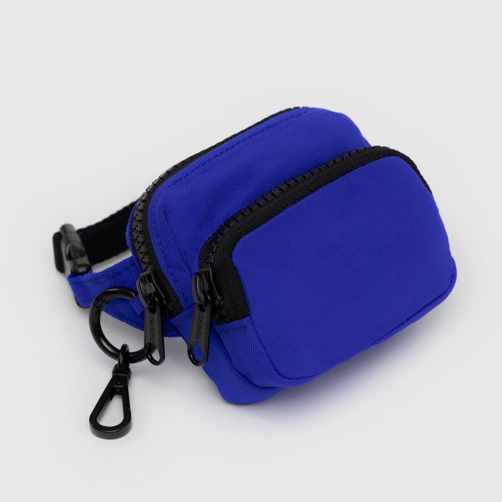 Bright blue coloured pouch with adjustable logo black strap, two zip pockets and metal keyring with clip.