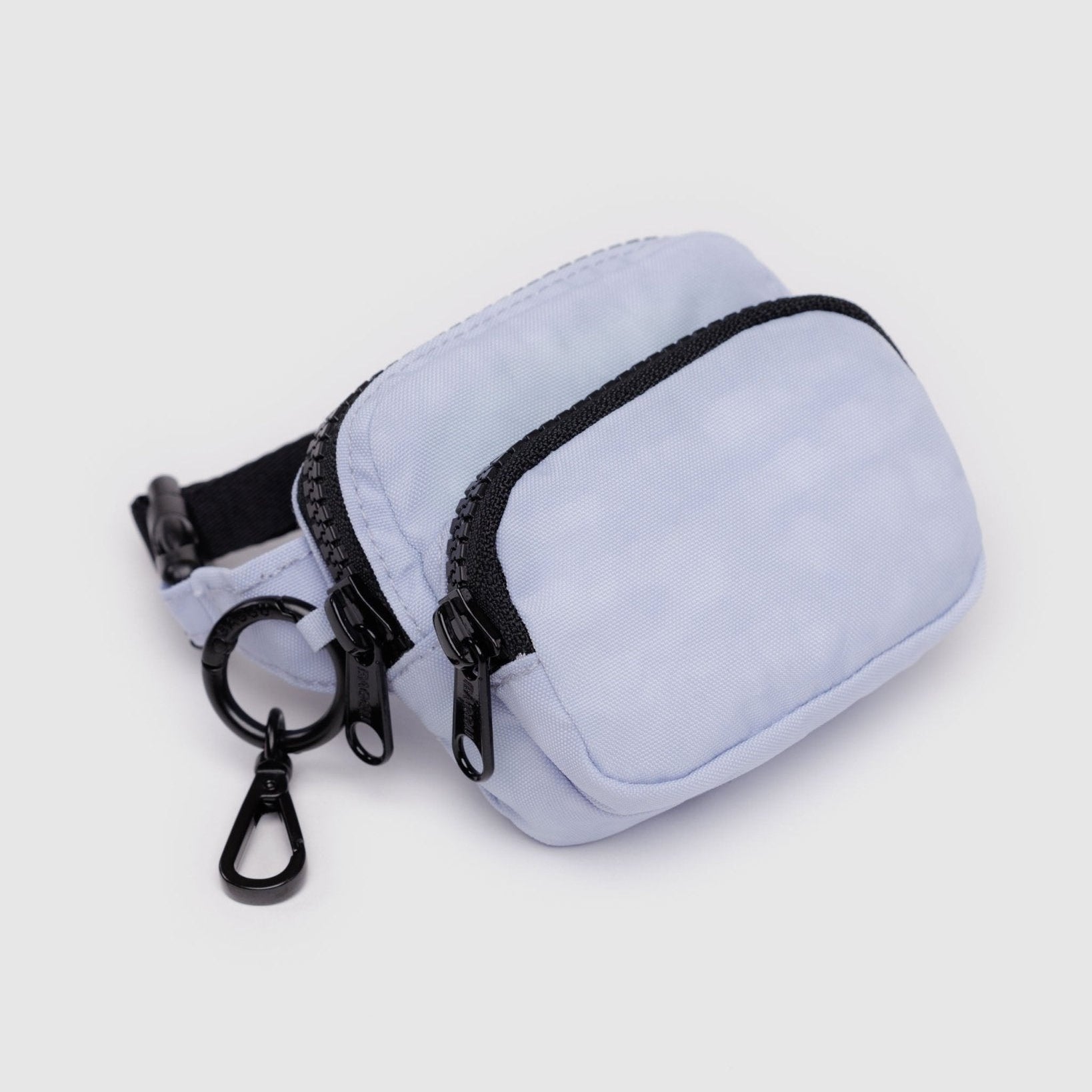 Light purple coloured pouch with adjustable logo black strap, two zip pockets and metal keyring with clip.