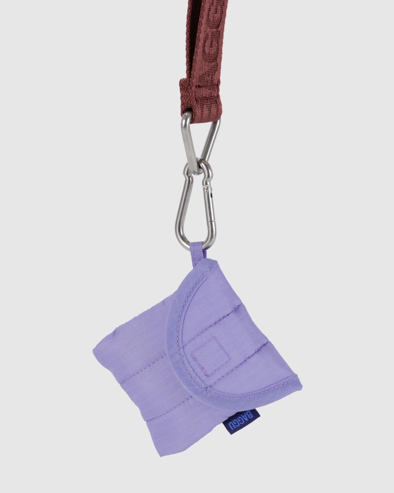 Quilted purple earbuds holder hanging on a carabiner burgundy keychain through side loop