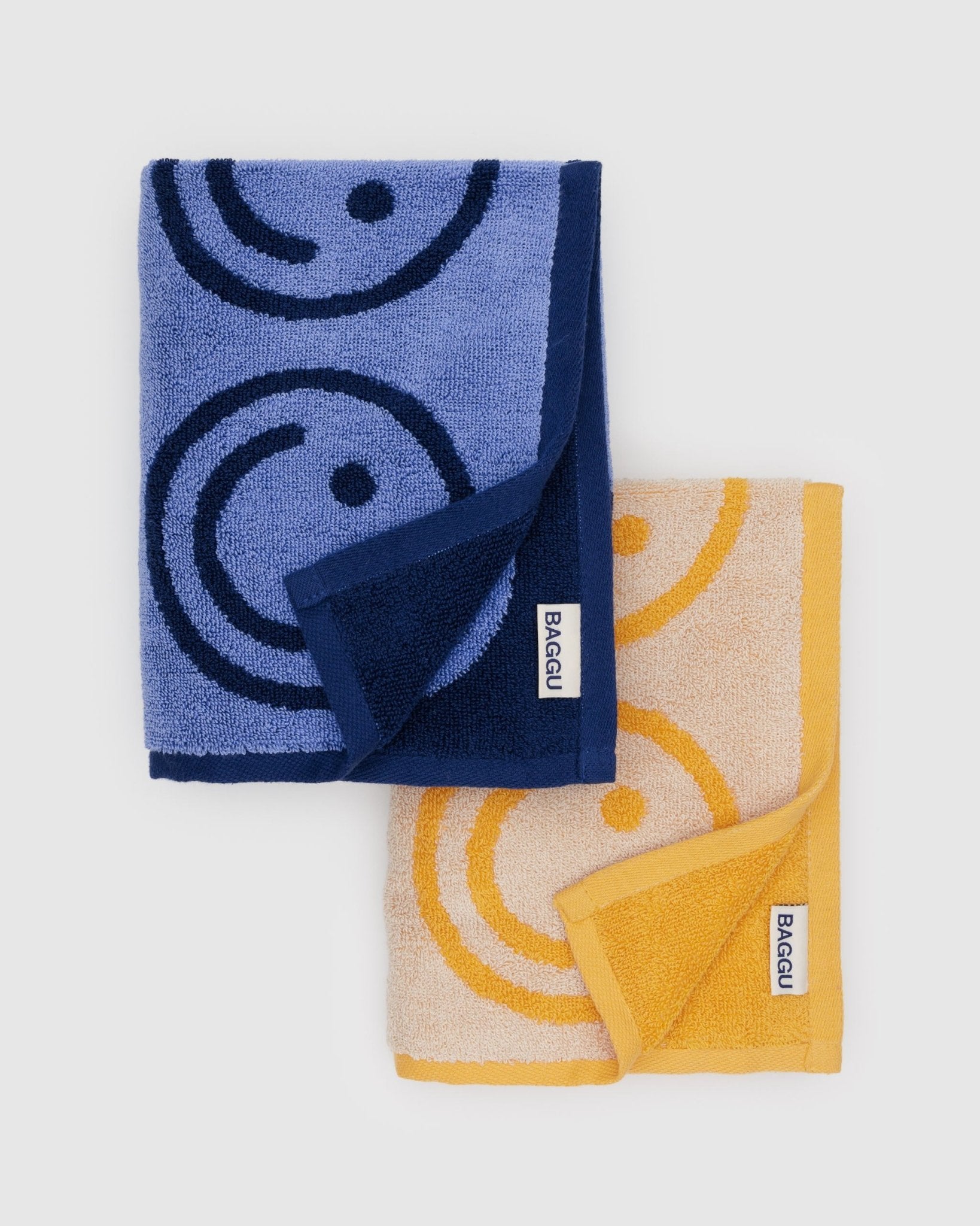 set of blue and yellow hand towels with smiley face print with BAGGU label