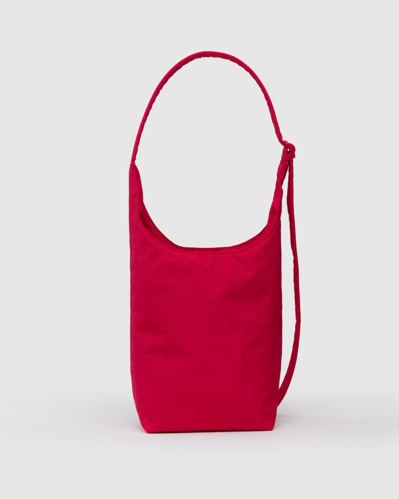 Back of red small shoulder bag with adjustable strap