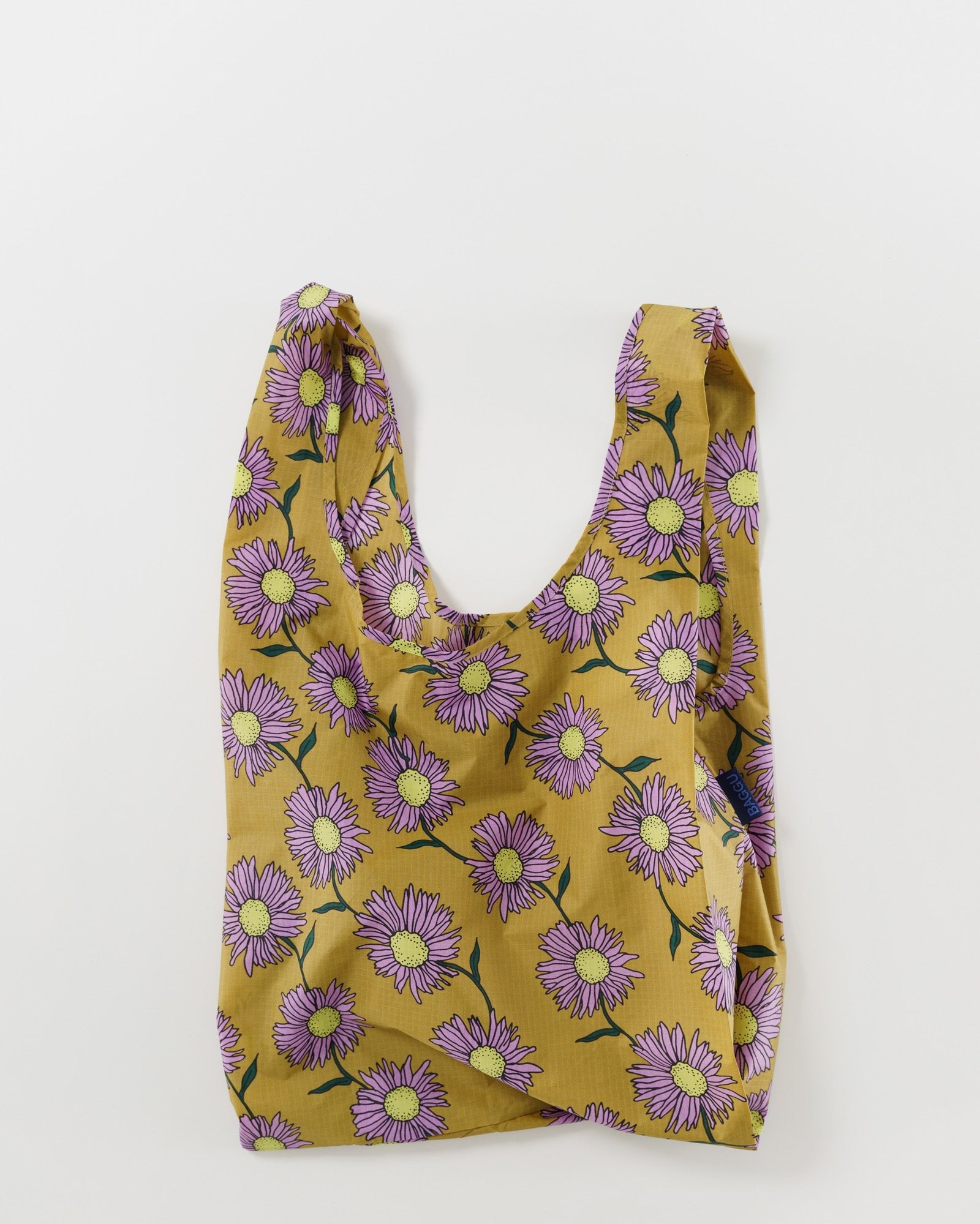Reusable shopping bag with purple daisy floral pattern on a mustard yellow background
