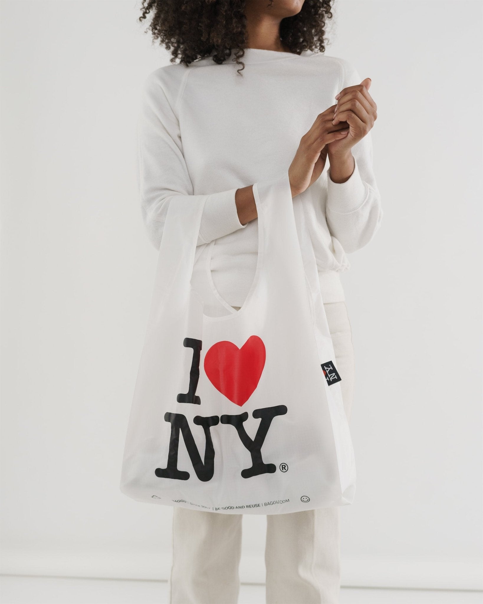 Person holding Standard Baggu Reusable Bag on arm with printed words - ANNIE.G