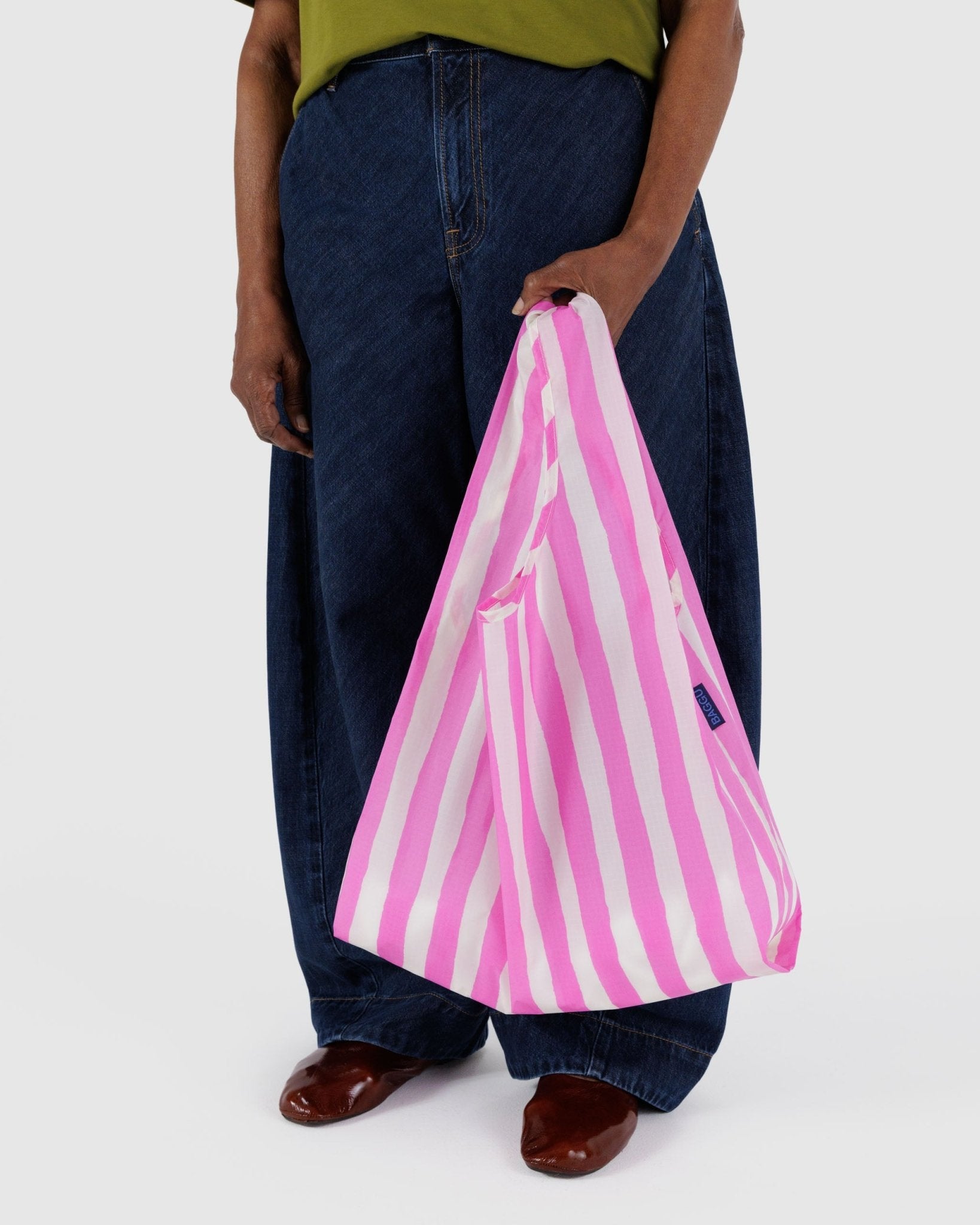 Person holding a Baggu Standard Baggu Reusable Bag in pink stripe - ANNIE.G