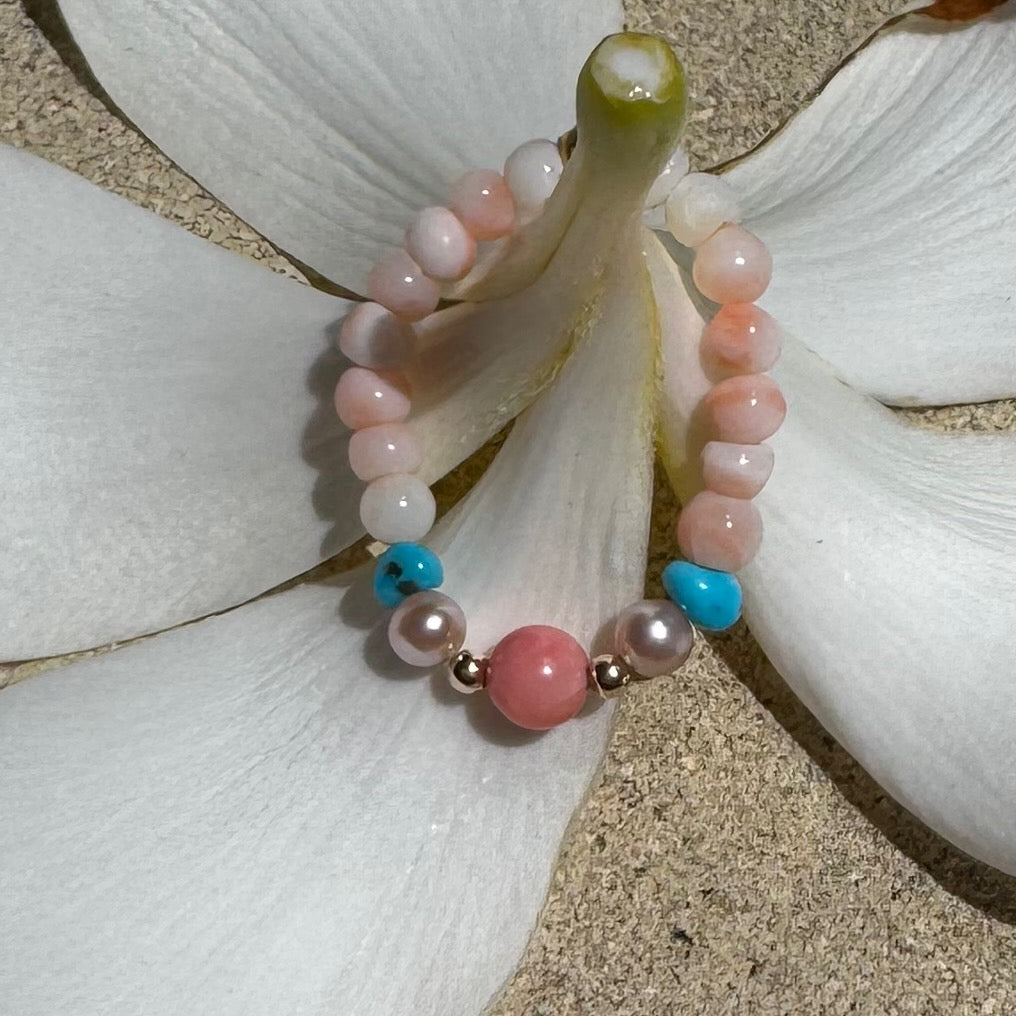Bead Stretch Ring in natural stones on the stem of a frangipani