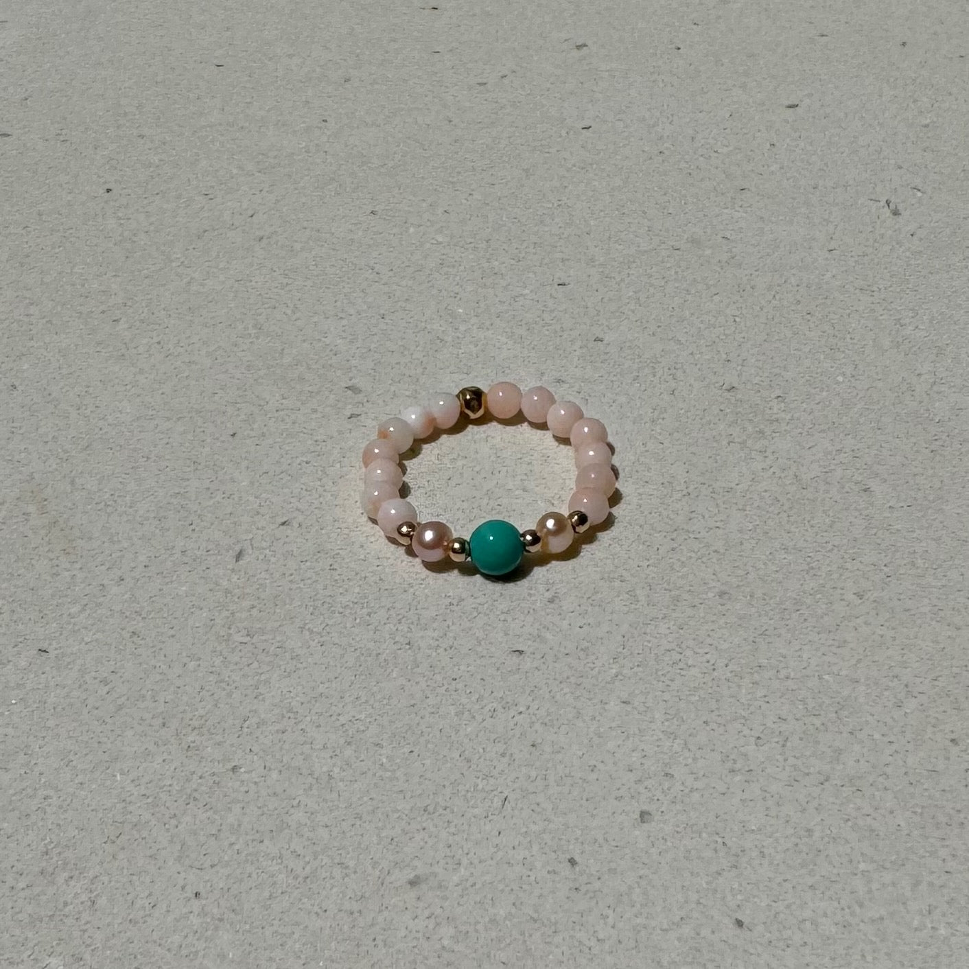 a natural stone Bead Stretch Ring on a bench