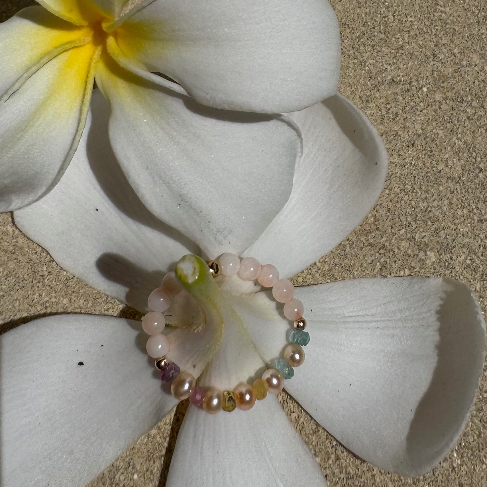 Bead Stretch Ring on a white flower stem