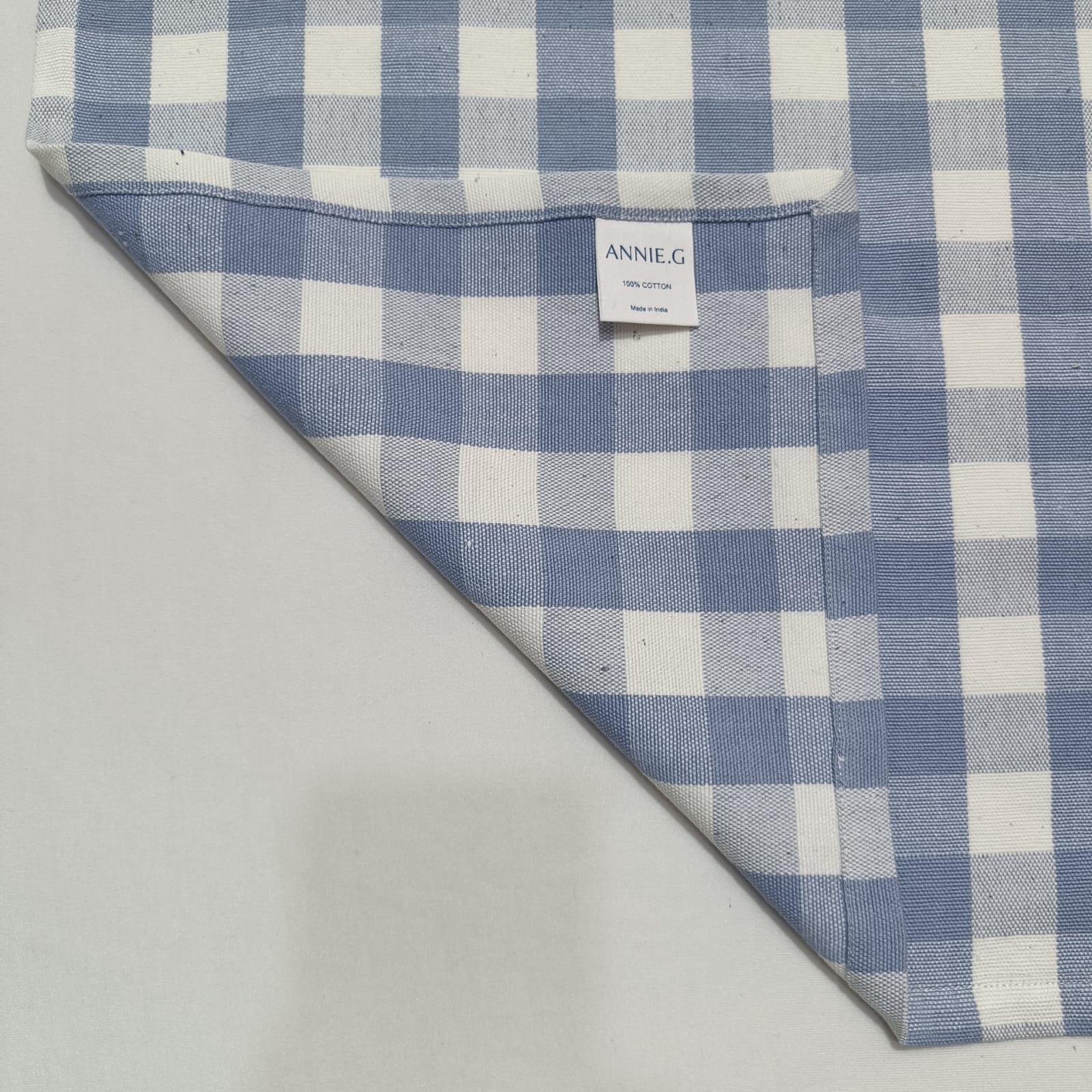 periwinkle-check-gingham-napkin-folded-in-half-showing-brand-label