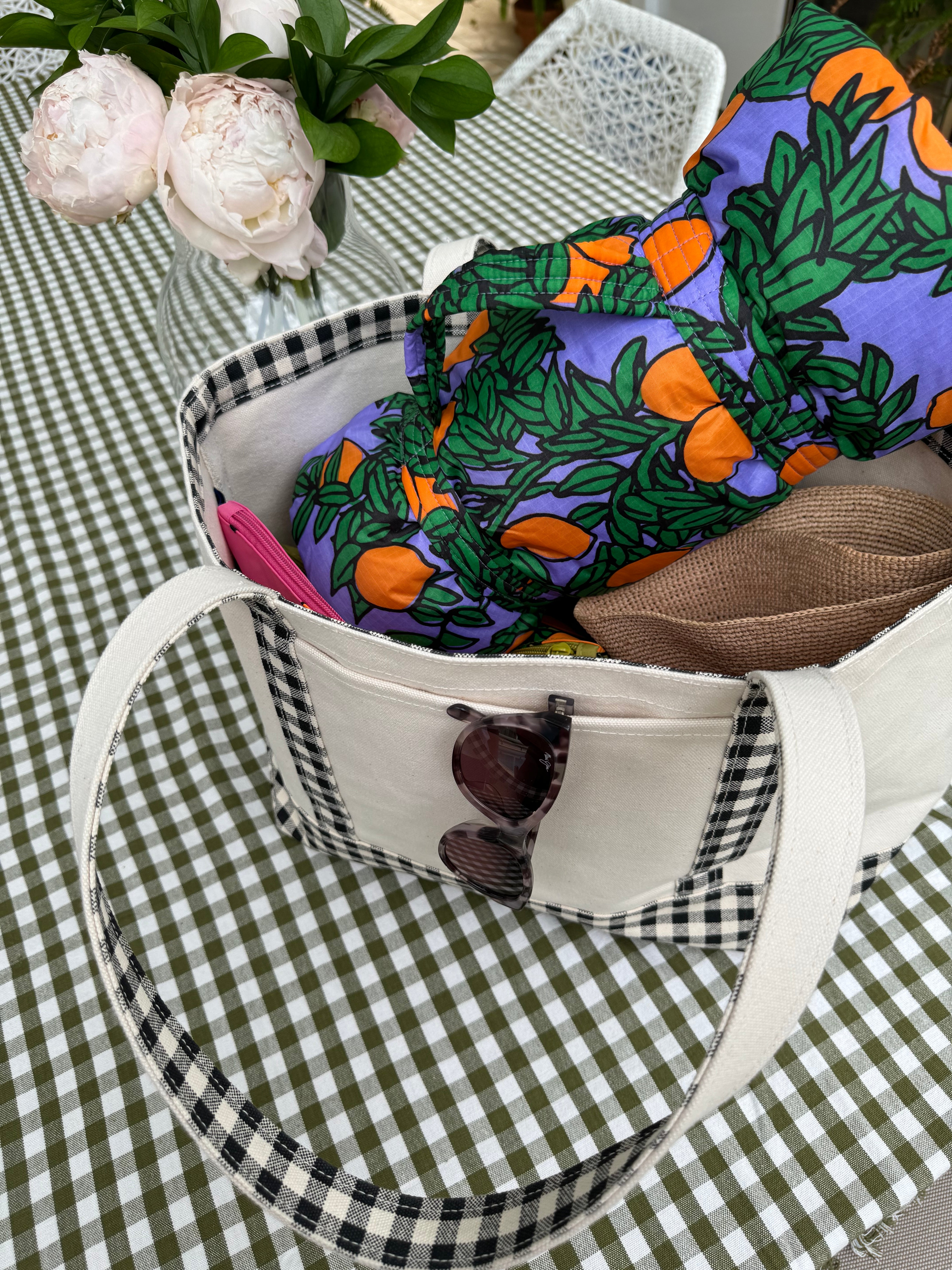 olive-gingham-tablecloth-on-table-with-bag-sitting-on-top-and-flower-vase