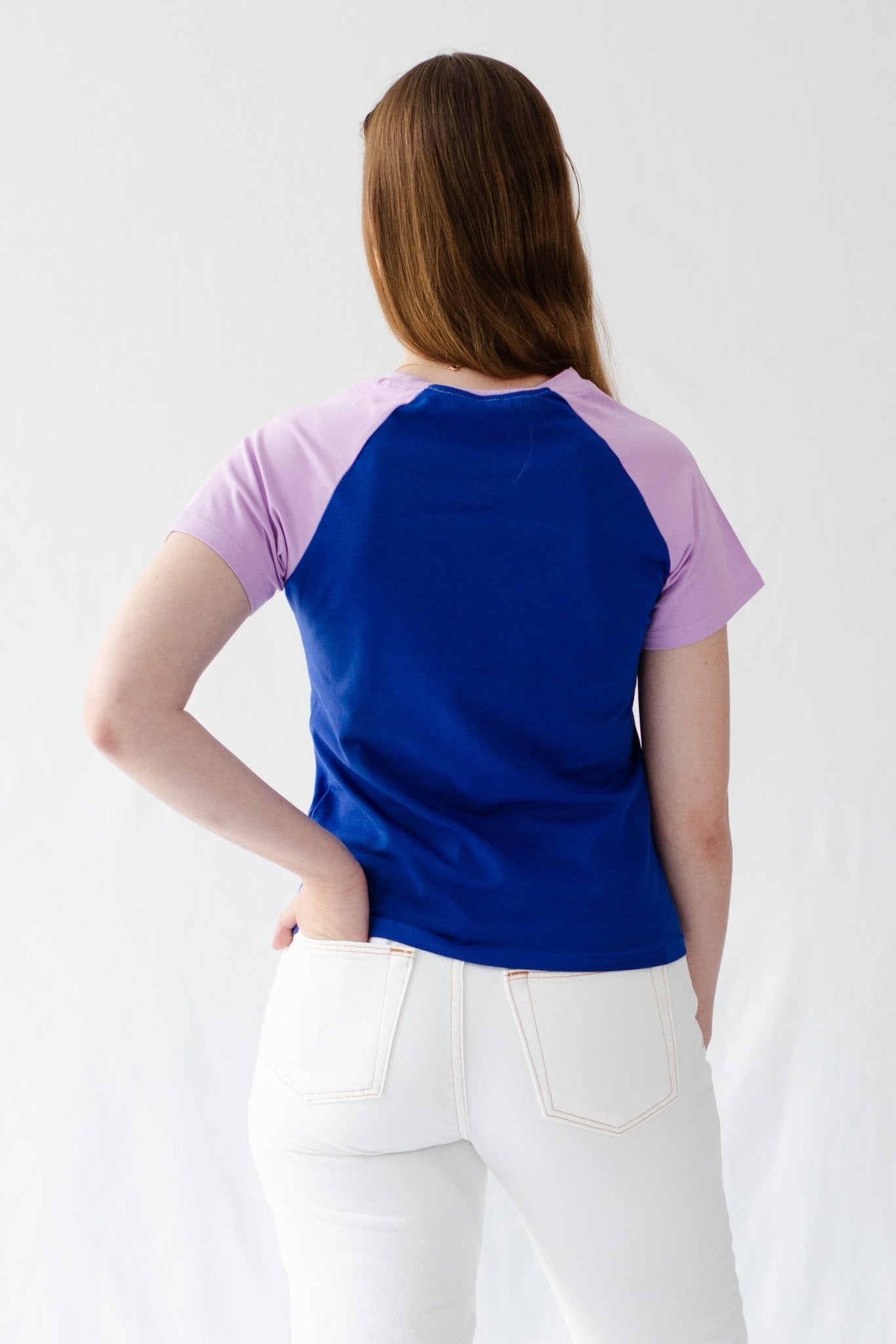 Back of a woman wearing a blue t-Shirt with lavender short sleeves - ANNIE.G