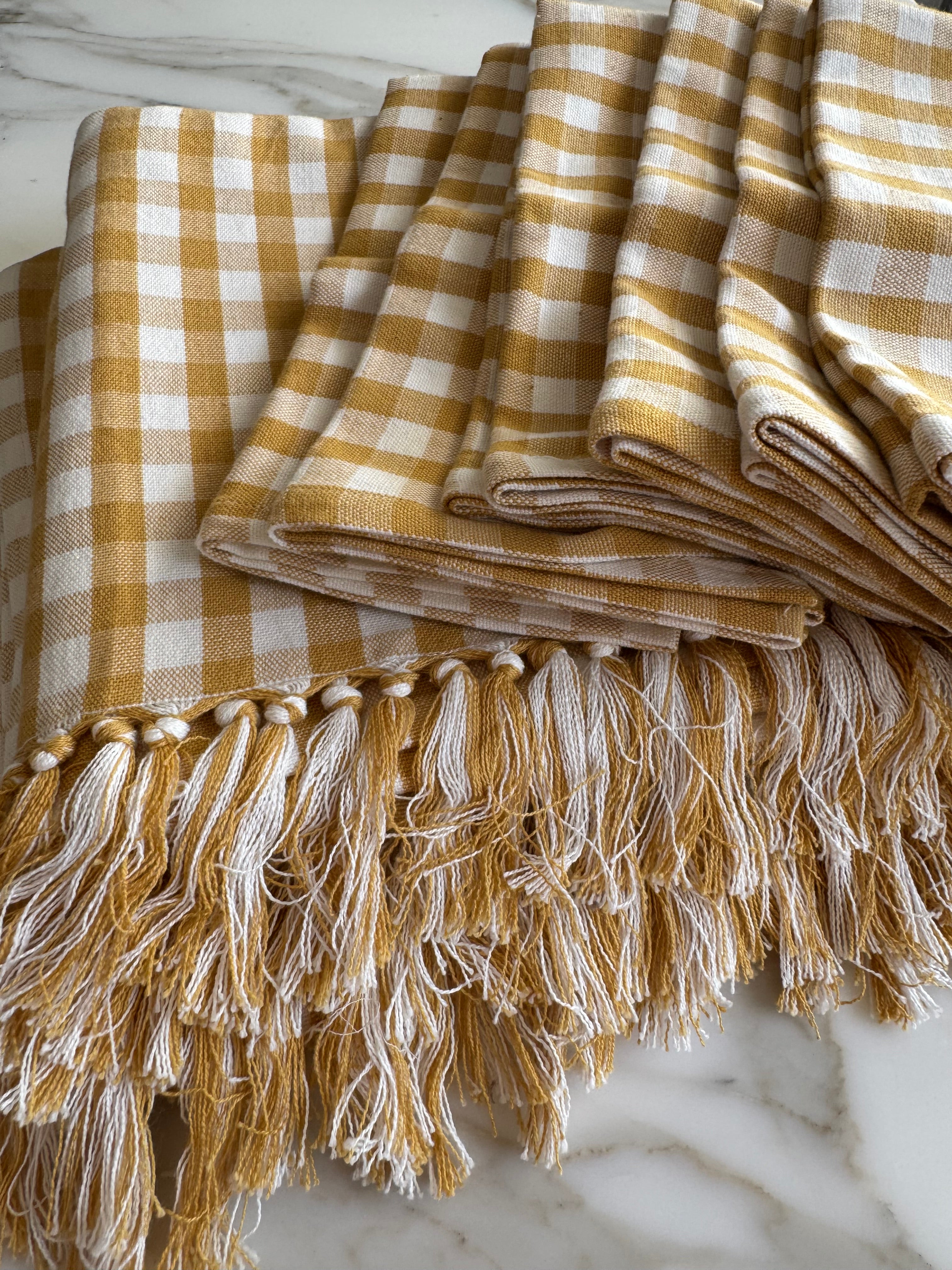 folded-gold-gingham-cotton-tablecloth-with-hand-knotted-edge-and-set-of-matching-napkins