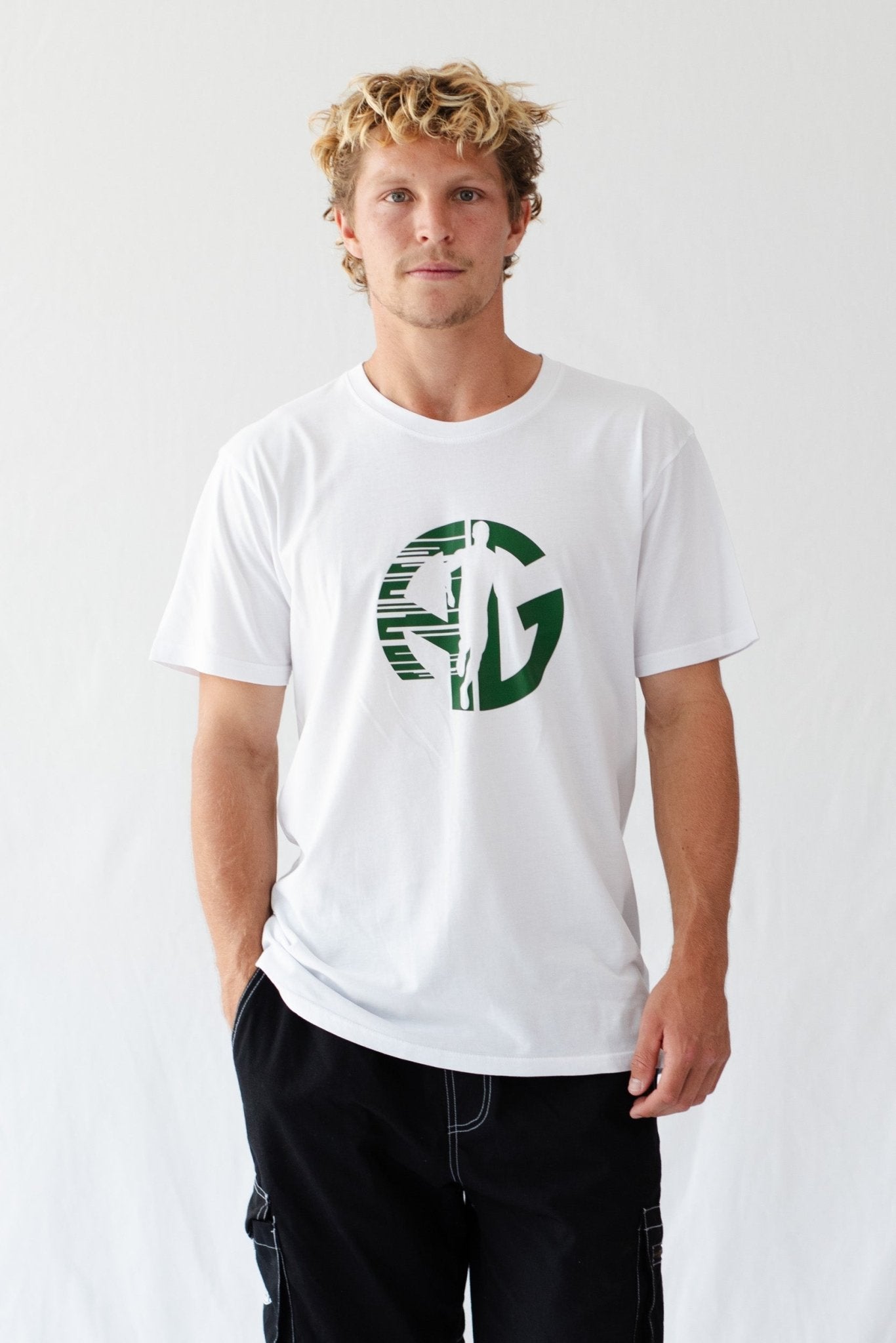 Man wearing a white t-shirt with a green 'AG' logo and running man priint.