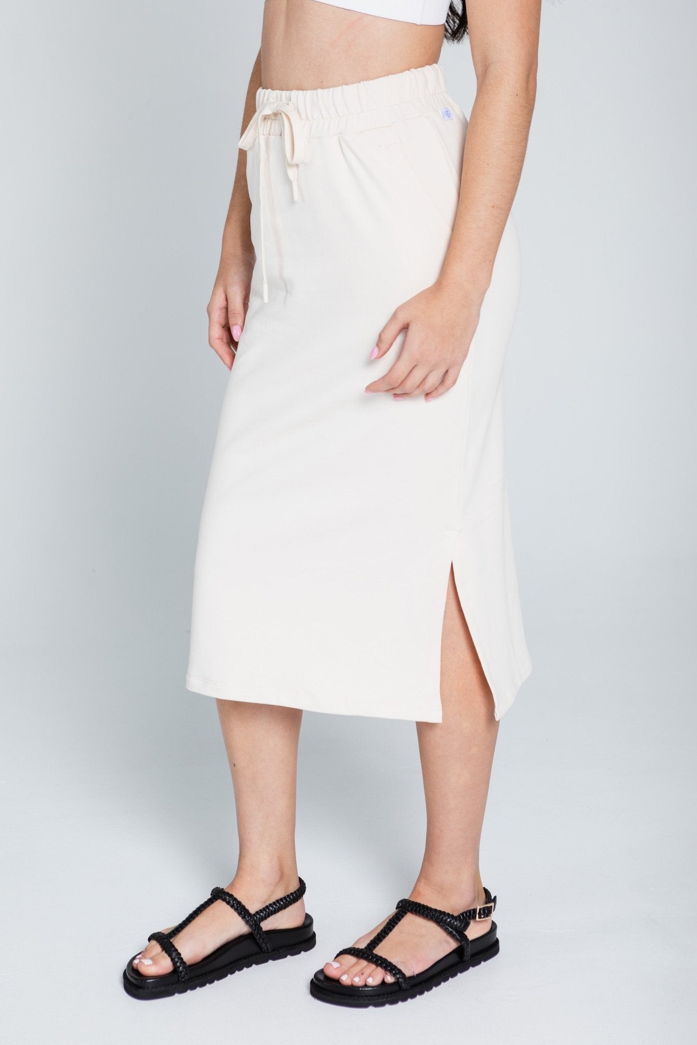 Woman wearing cream Monterey Skirt with elastic waist, pockets and side slits - ANNIE.G