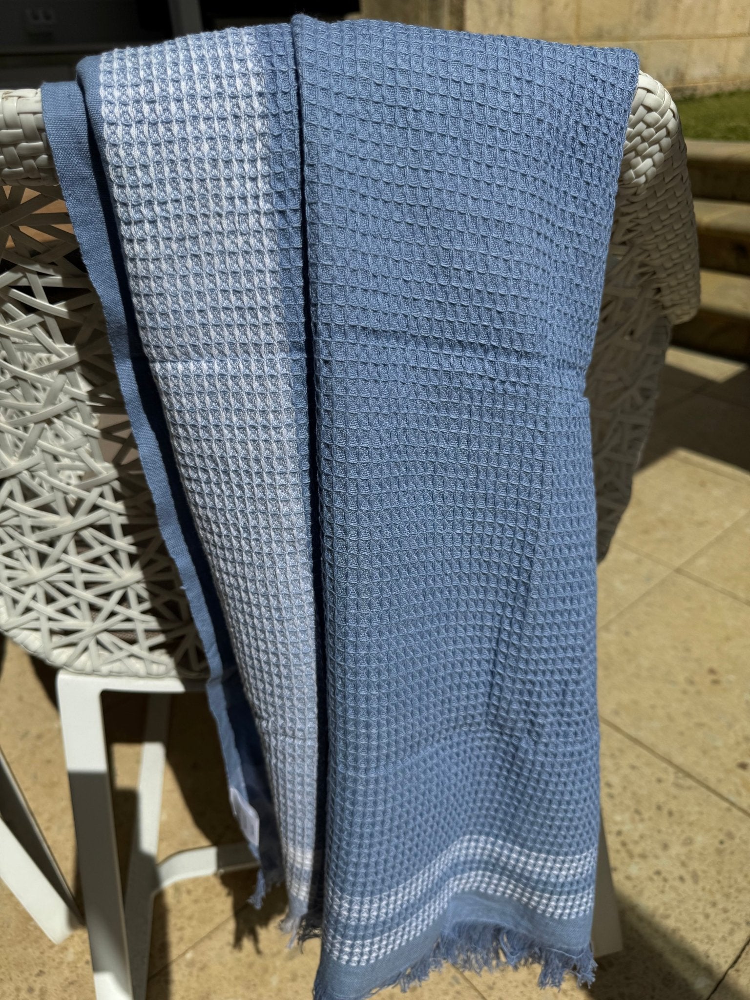 Periwinkle Border Waffle Towel over a chair - ANNIE.G
