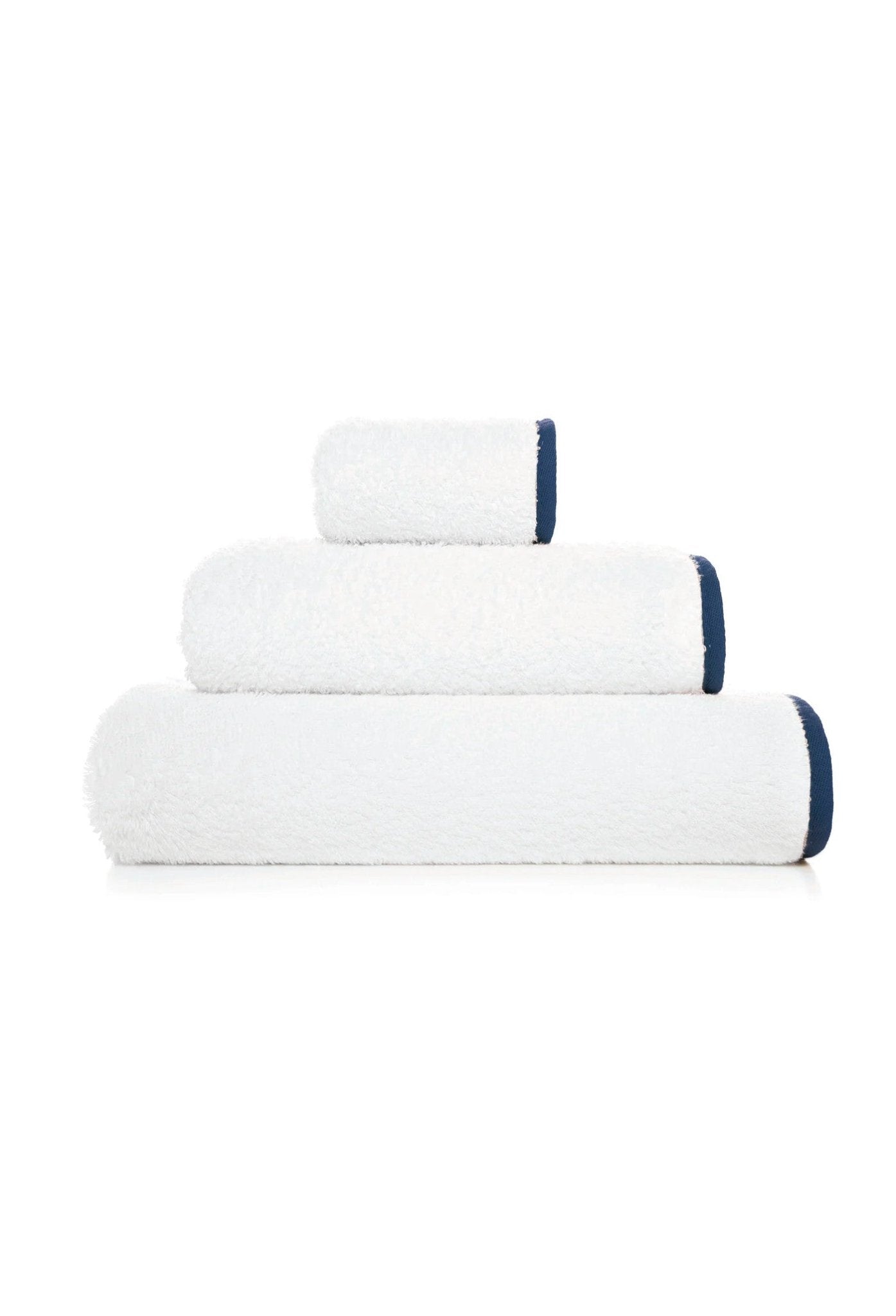 Folded stack of white bath towel, hand towel and face washer with navy bias binding edge.