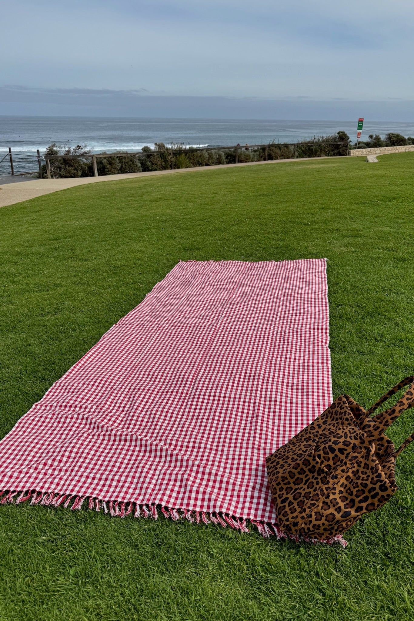 Red Gingham Cotton Tablecloth on green grass by the beach - ANNIE.G