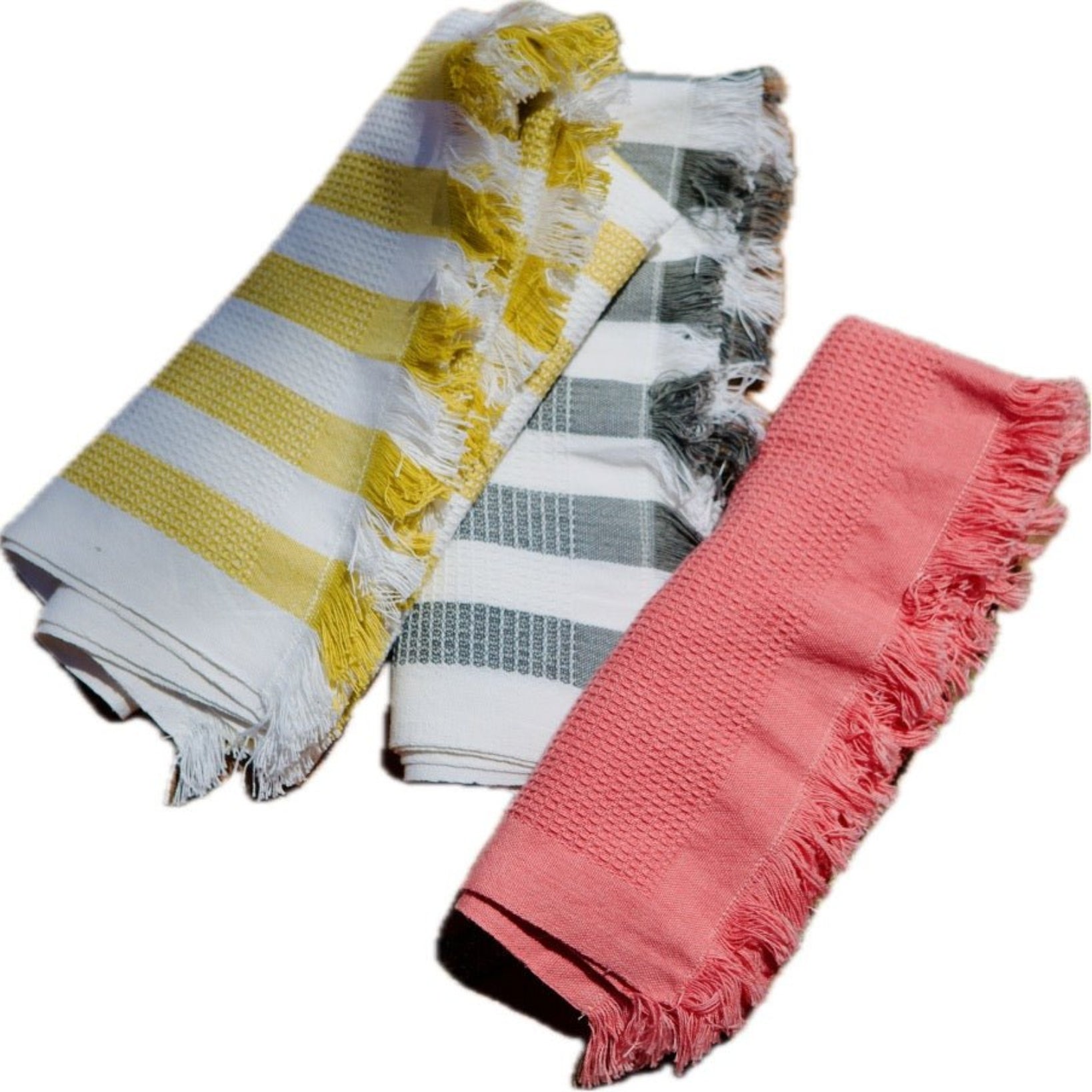 Three rolled cotton waffle weave hand towels in pink, yellow and white stripe and grey and white stripe.
