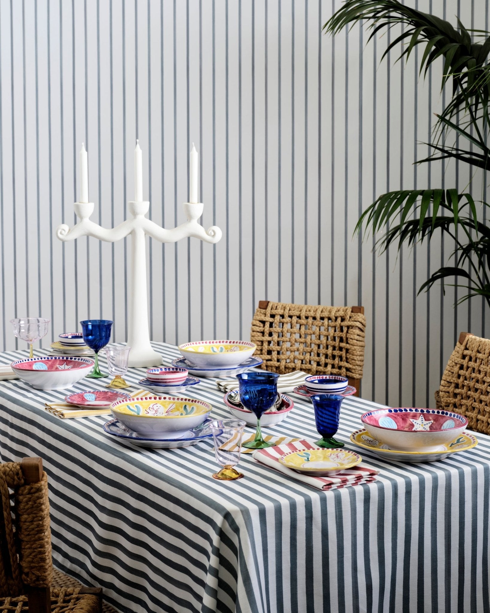 Hand painted blue striped tablecloth on a table in a dining room with a candelabra and table setting - ANNIE.G