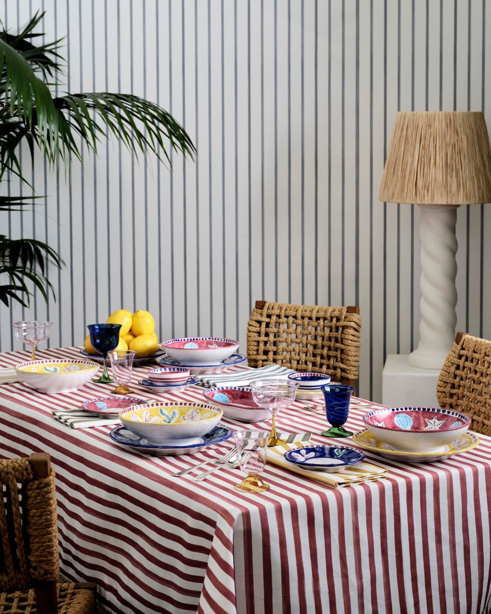 Hand painted terracotta striped tablecloth on a table in a dining room with a table setting and lamp - ANNIE.G
