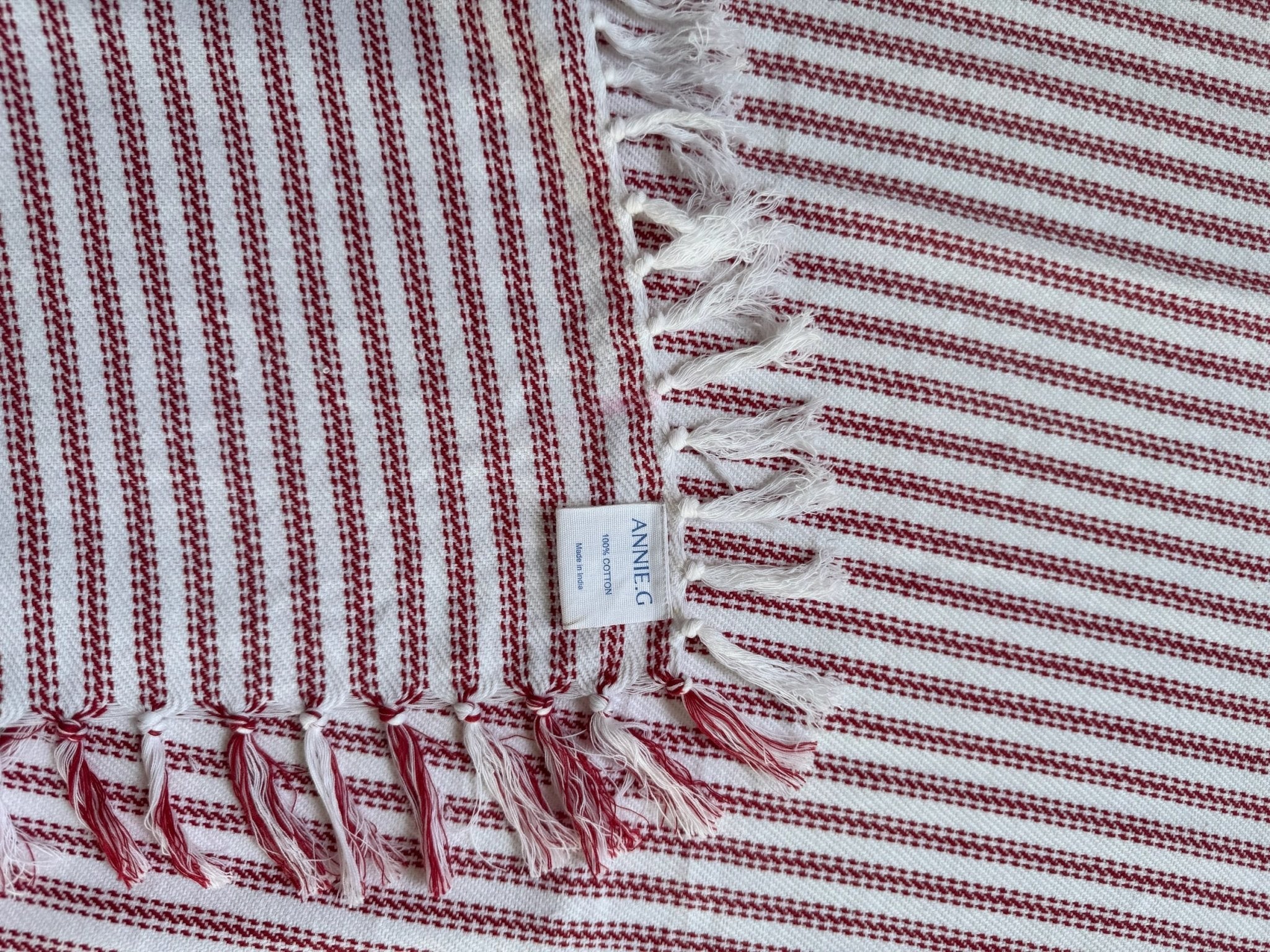 tablecloth-square-red-ticking-folded-edge-showing-brand-label-and-hand-knotted-edge