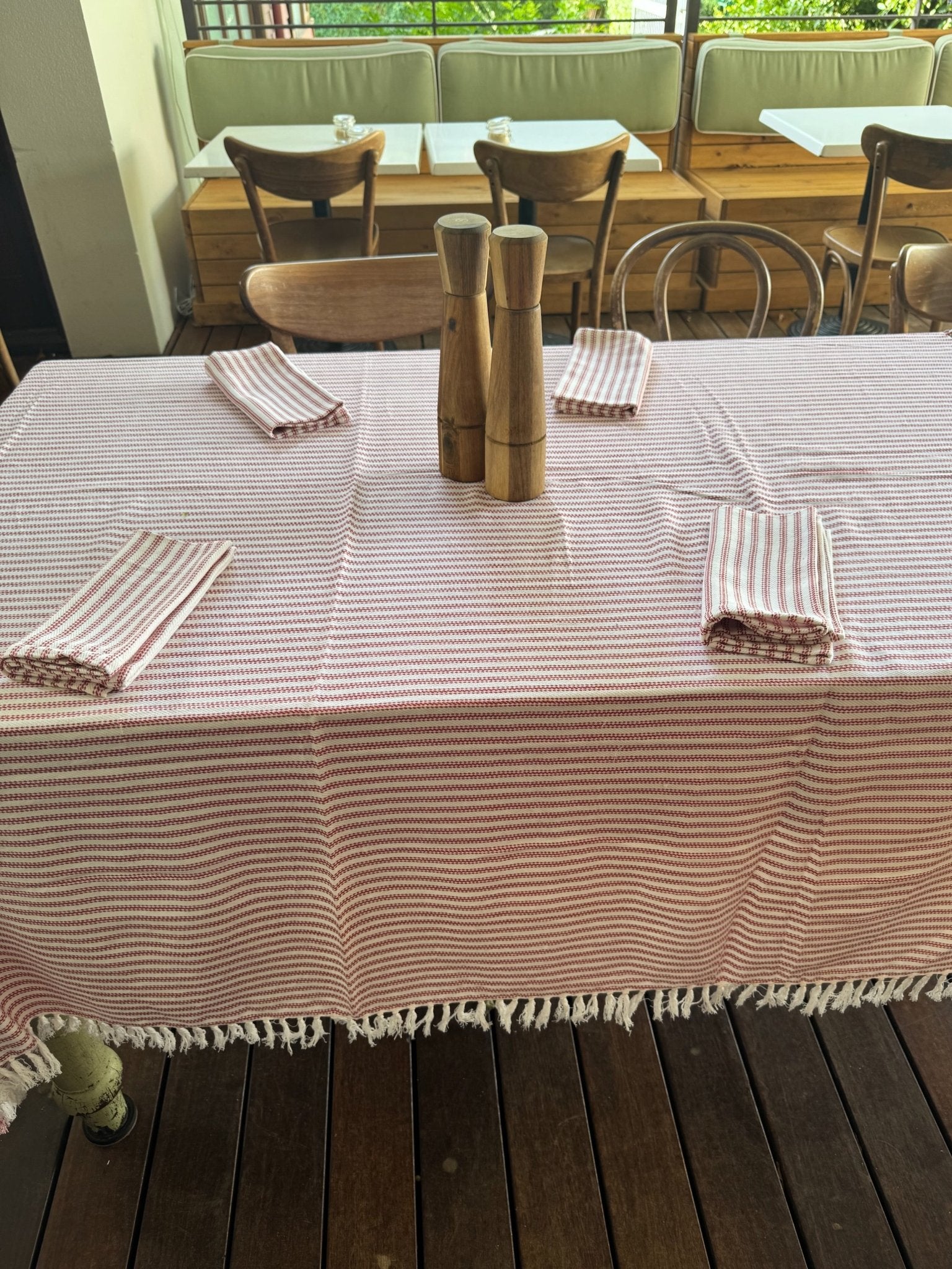 tablecloth-red-ticking-on-rectangle-table-with-napkins-on-table-setting-at-a-cafe