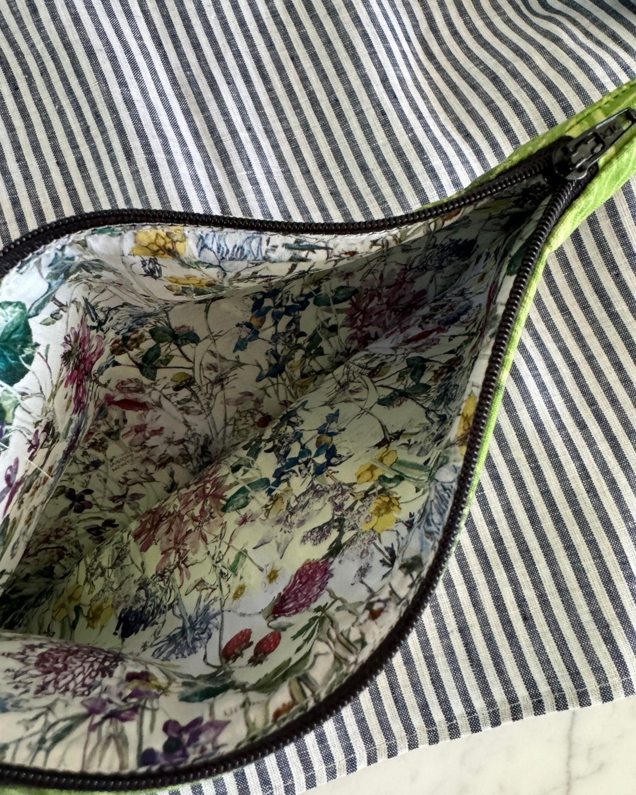 Inside floral lining of pouch and zip top.