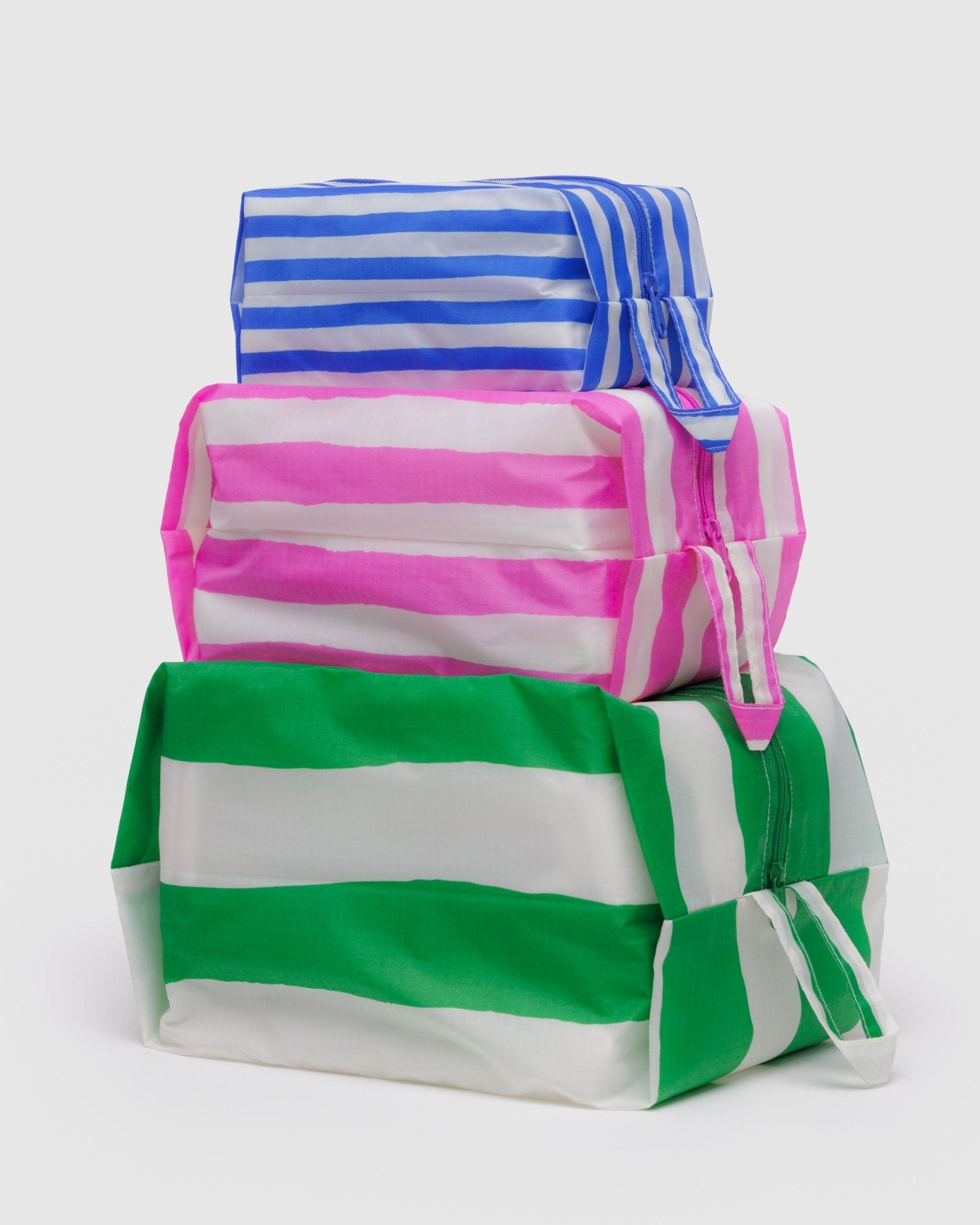 Stacked set of 3 expanded zip top bags each in a different size and colour stripe of blue, green or pink with hanging loop - ANNIE.G