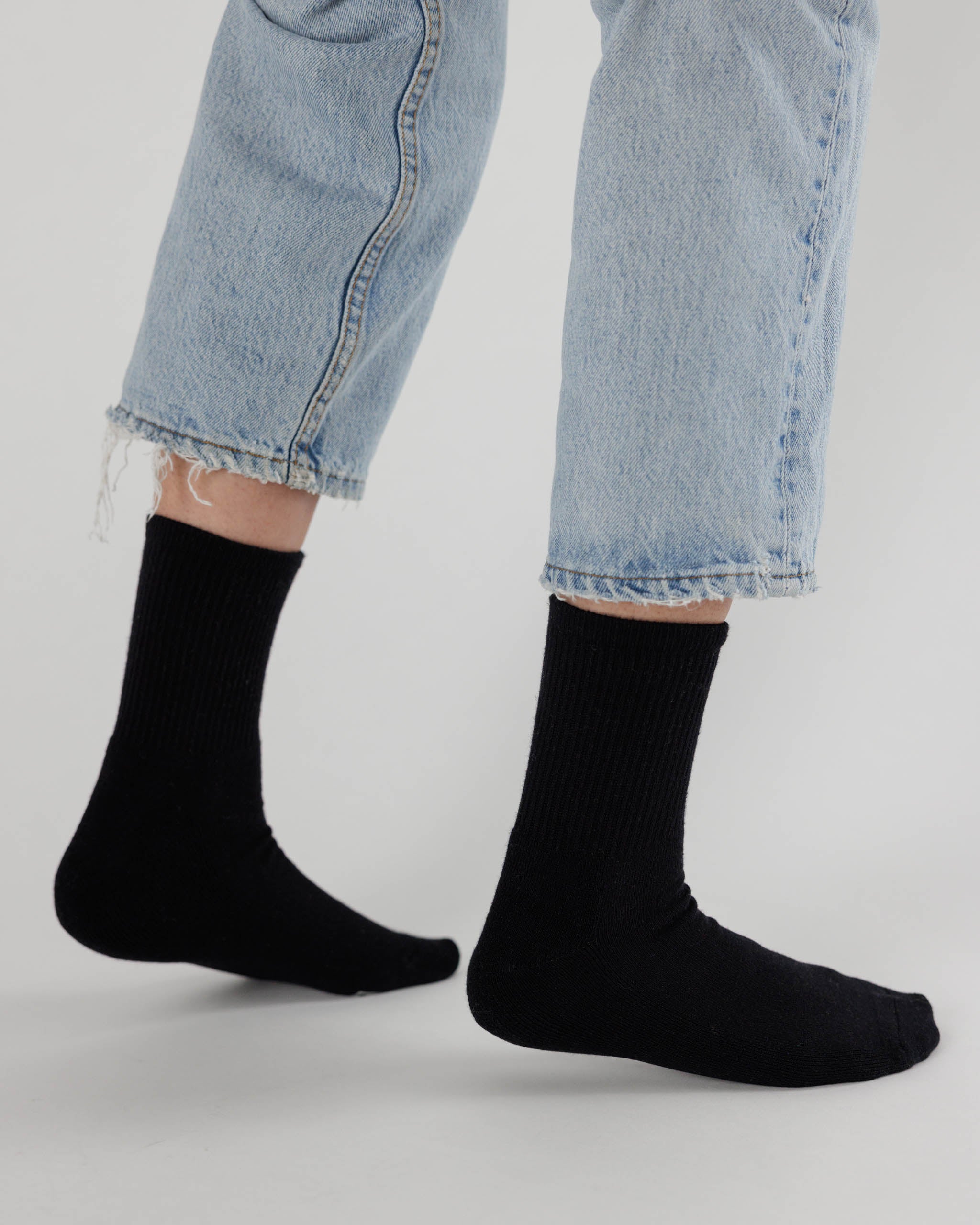 Black socks worn with light blue jeans.