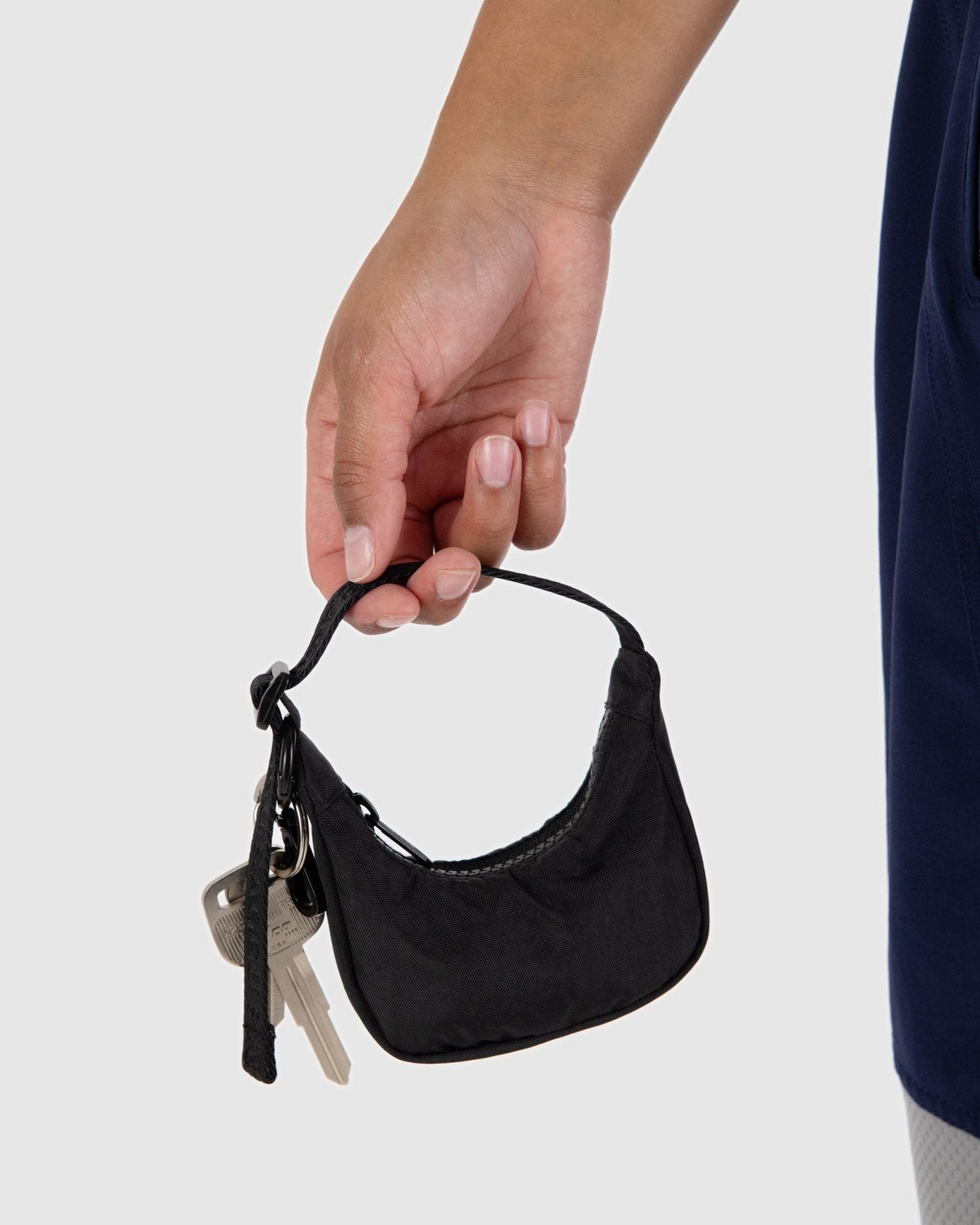 Person holding a black Crescent Bag Charm with keys attached - ANNIE.G